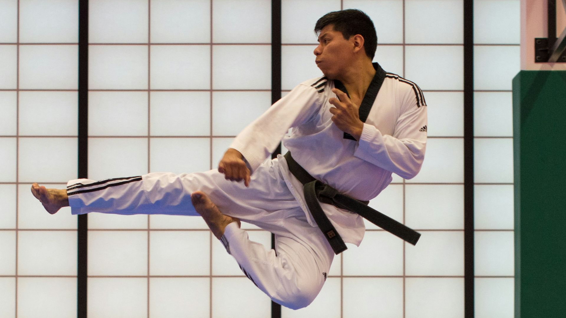 man doing karate stunts on gym