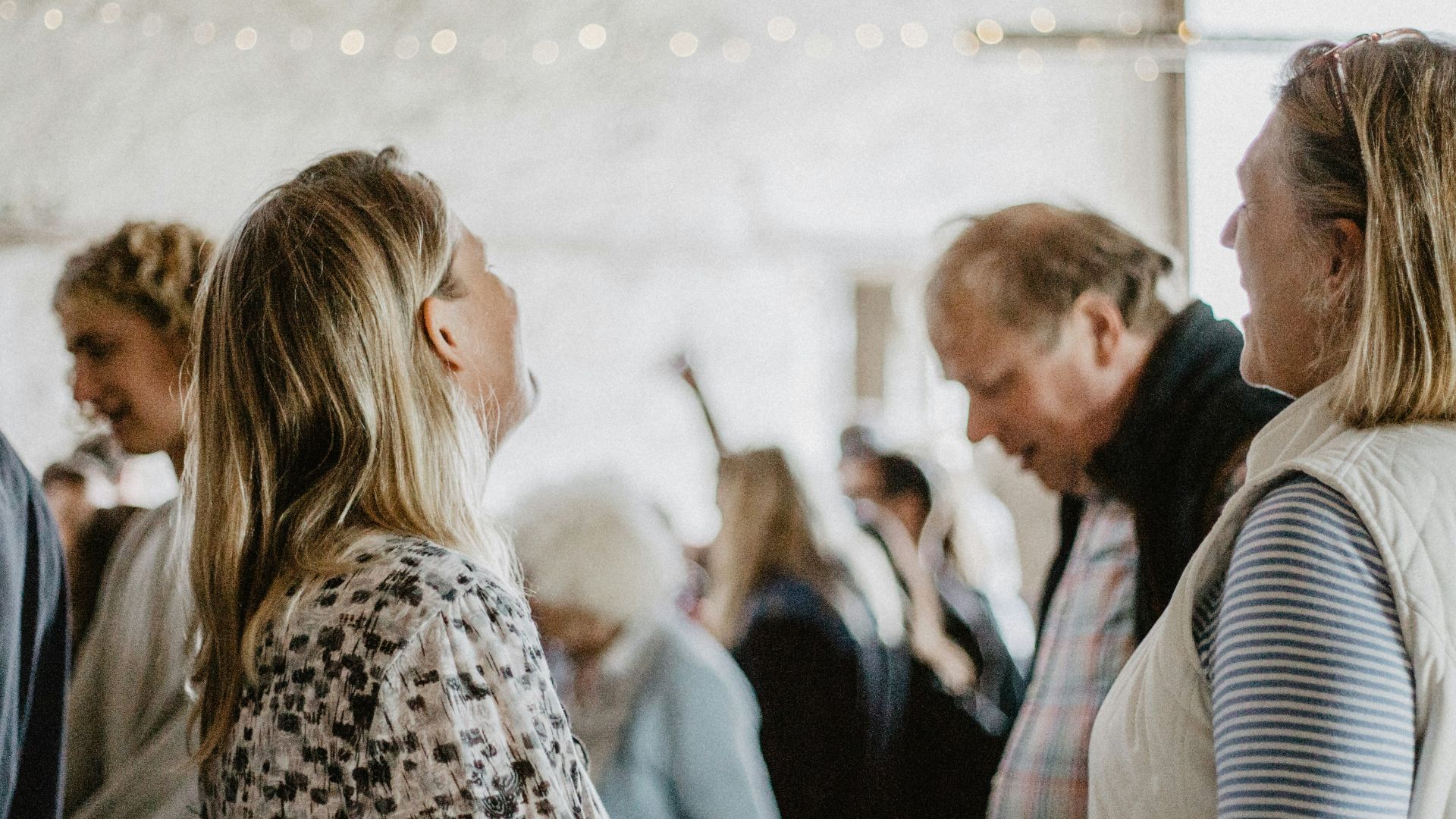 man in black suit jacket kissing woman in white and black leopard print coat