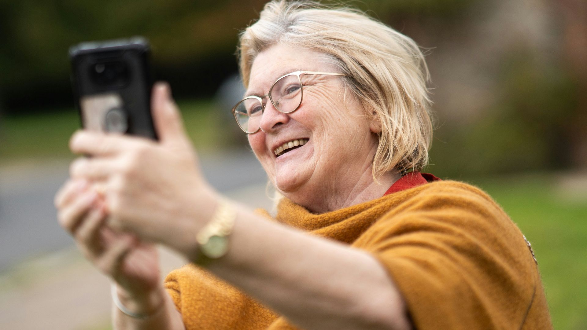 a woman taking a picture with her cell phone