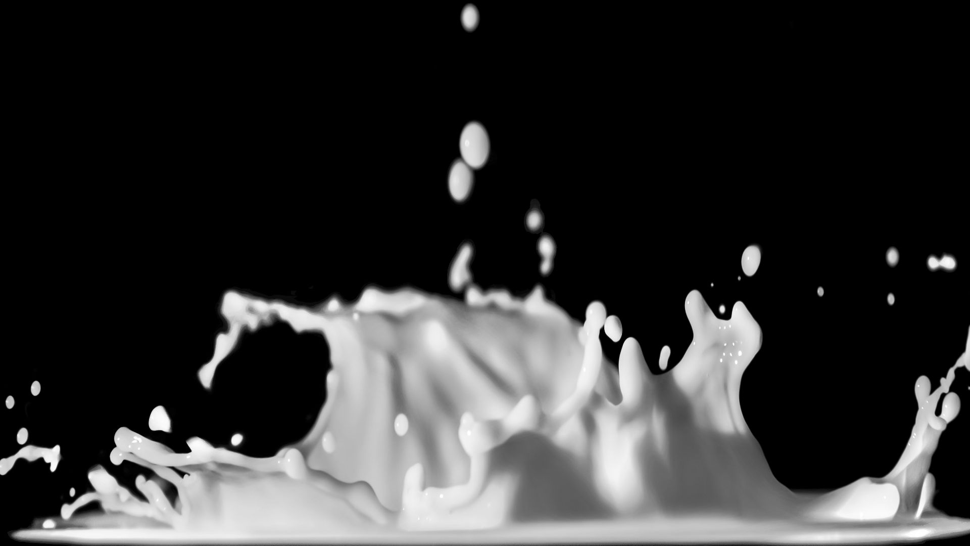 a black and white photo of a liquid splash