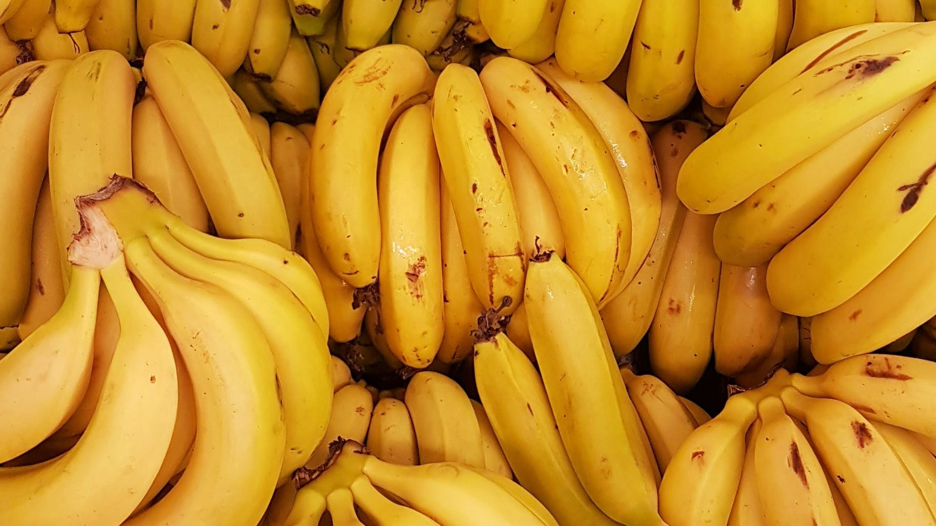 yellow banana fruit on brown wooden table