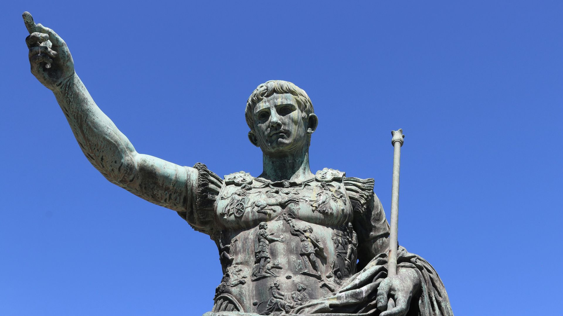 a statue of a person holding a staff