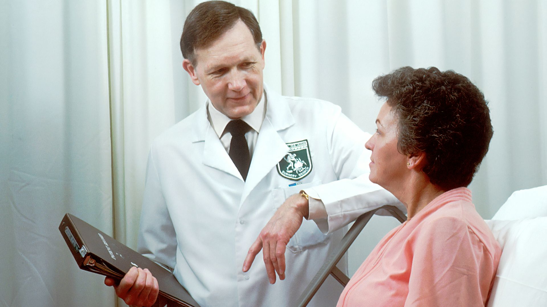 man in white button up shirt holding black tablet computer