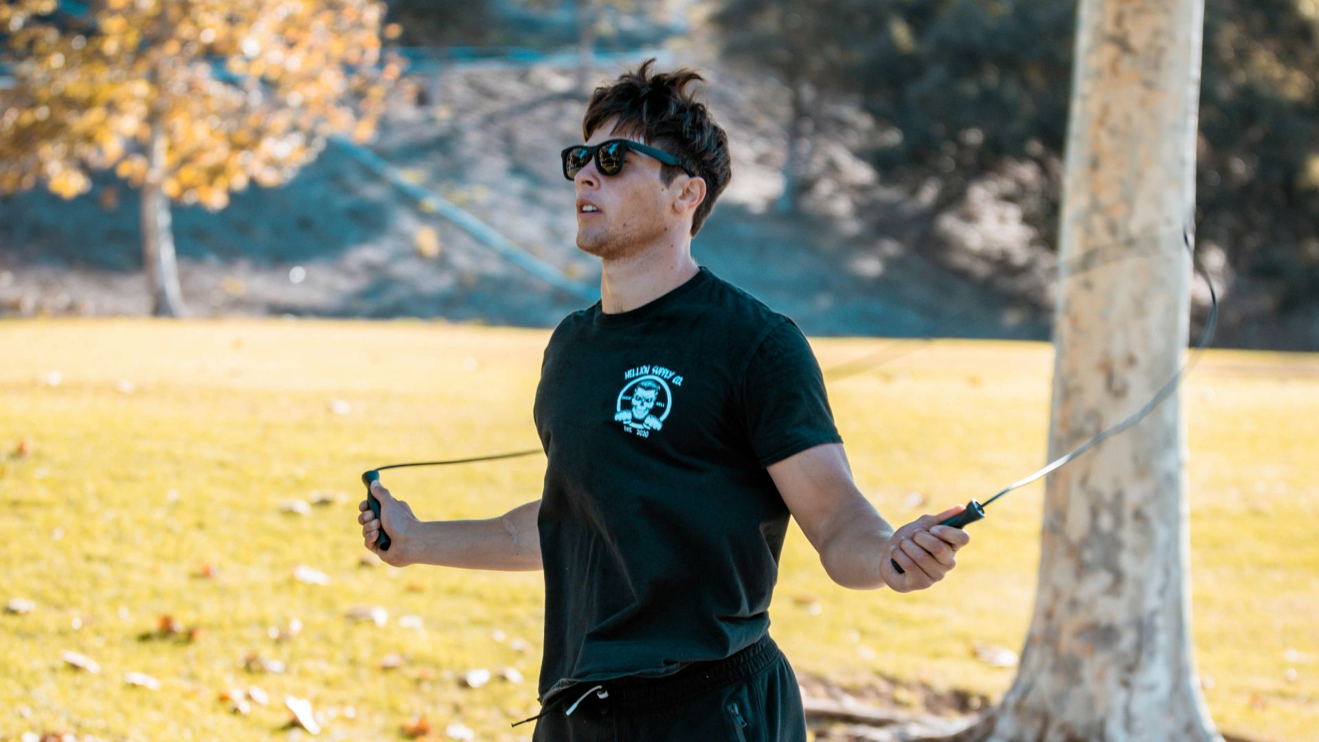 a man in a black shirt is flying a kite