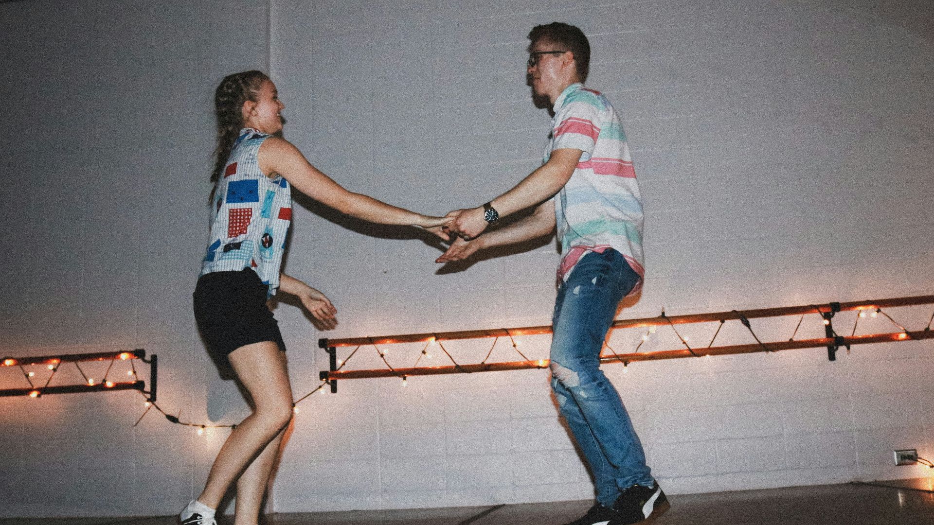 woman and man standing near wall