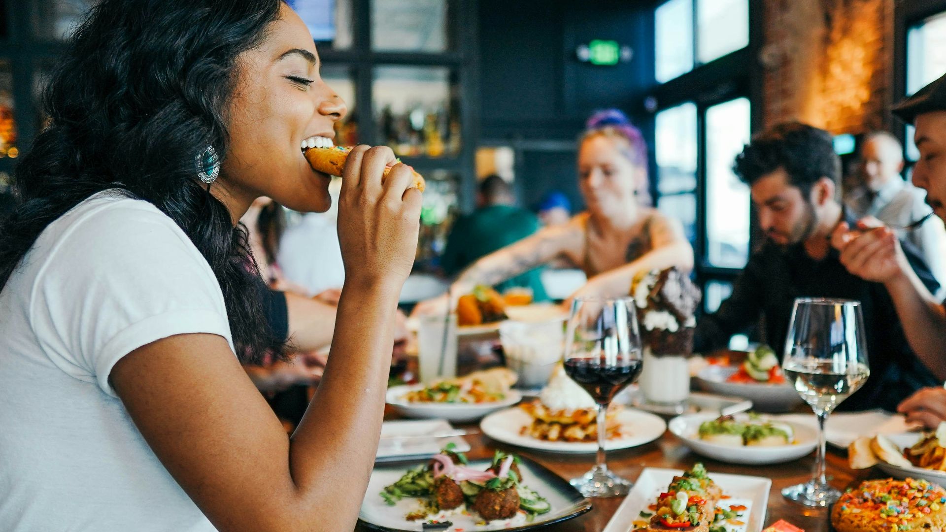 woman in white shirt eating