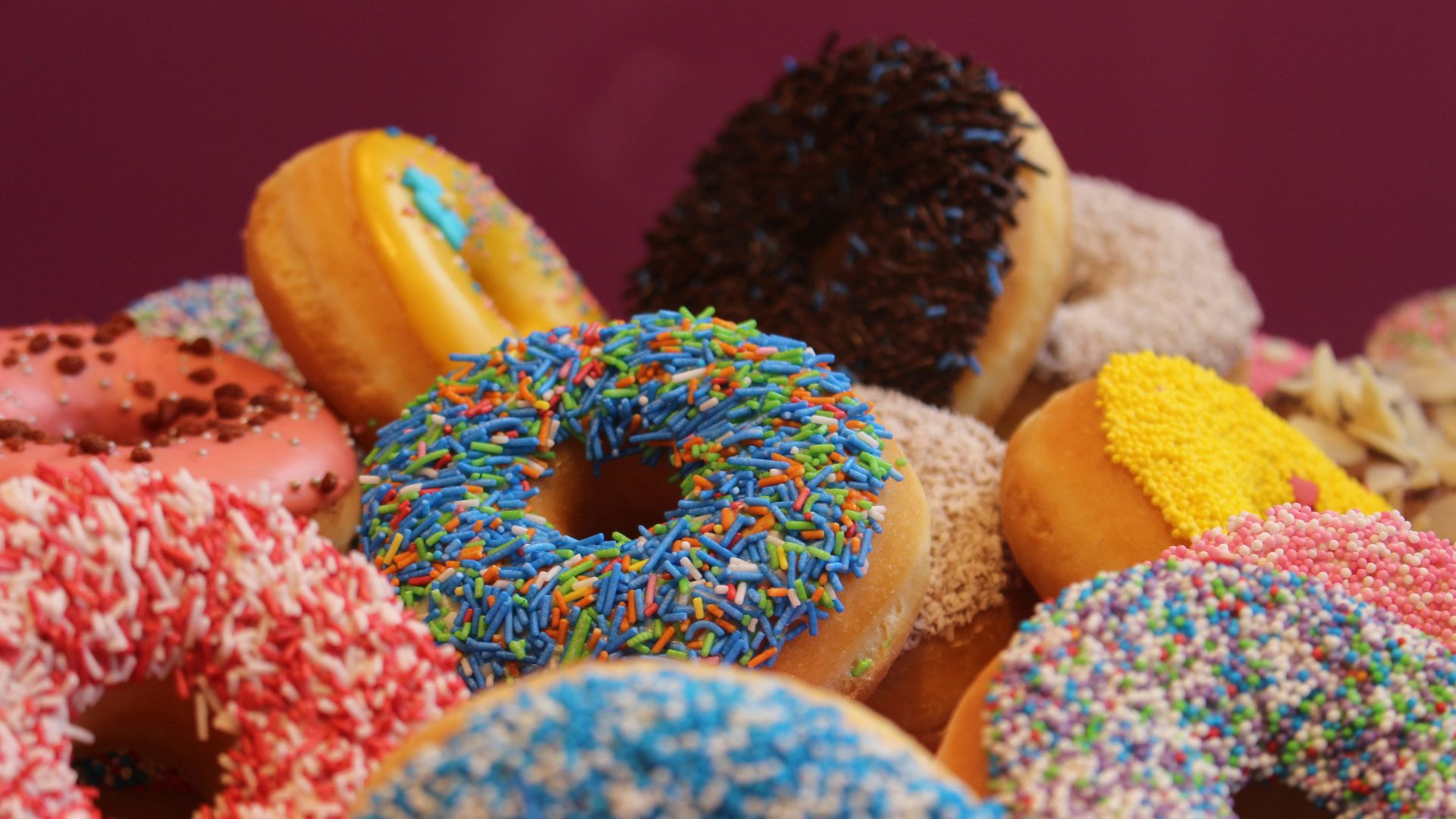 blue and pink doughnut on white textile