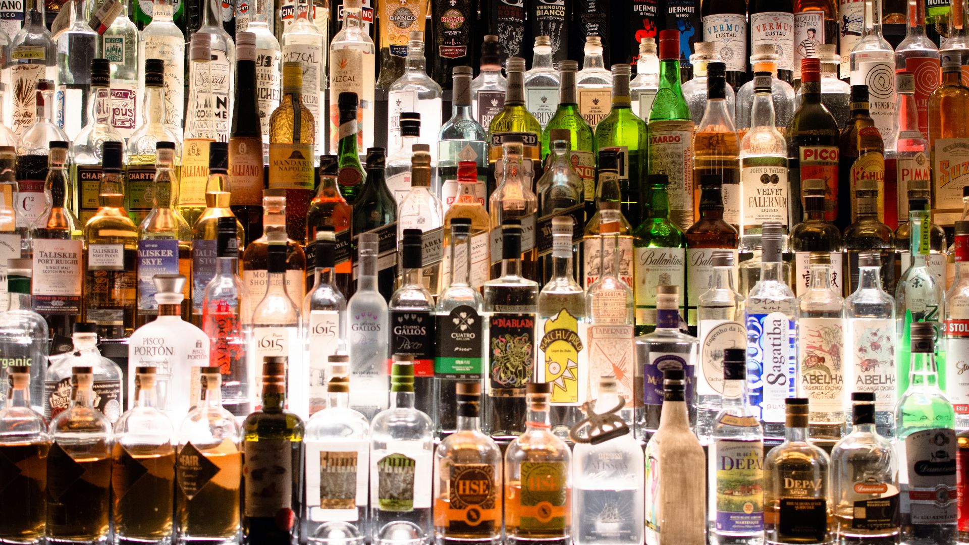 assorted liquor, wines, and whisky on display