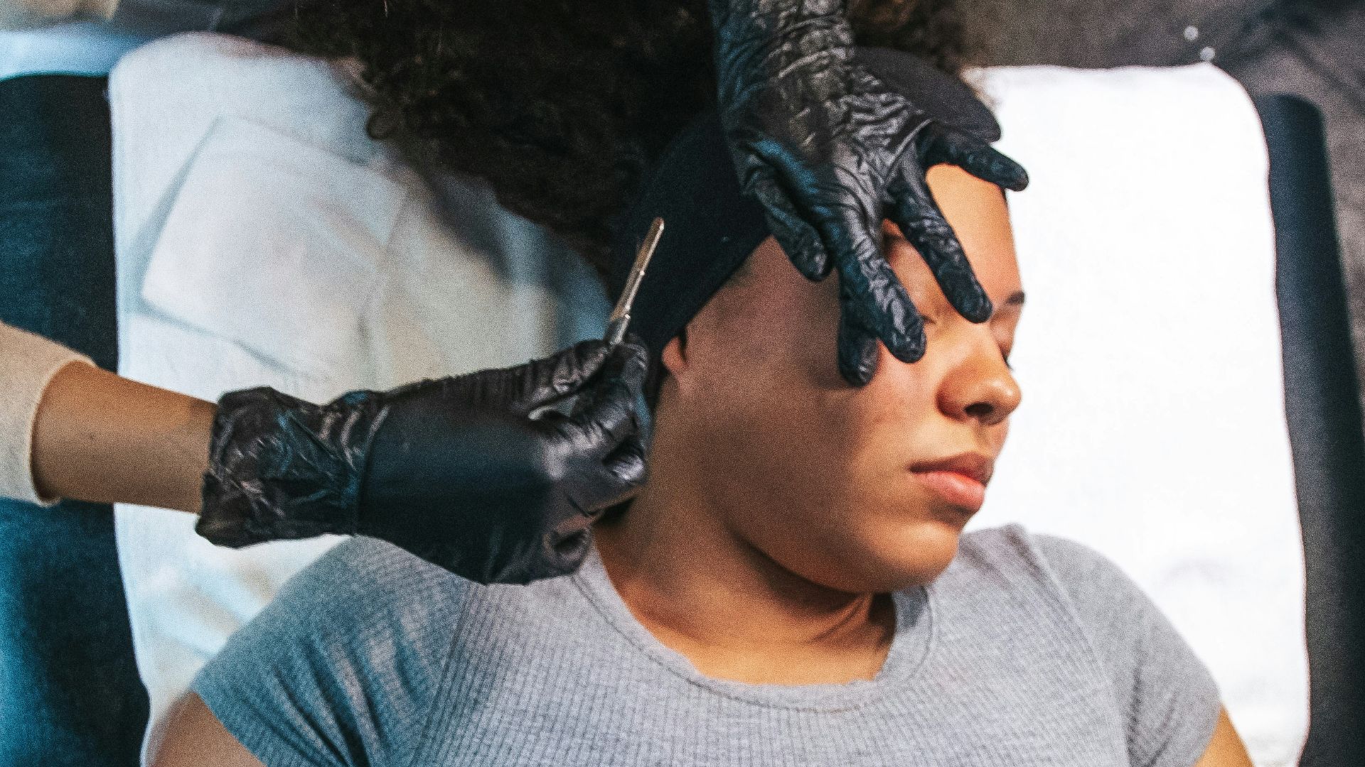 a woman getting her hair cut by a hair stylist