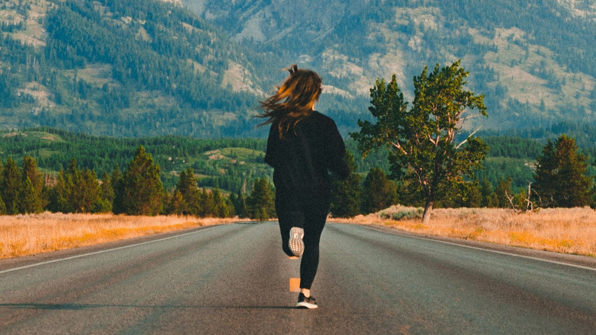 woman walking on road during daytime