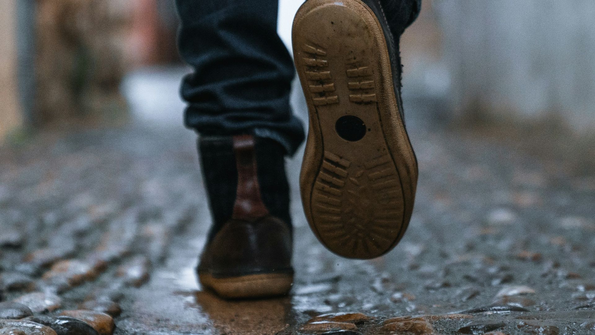 close-up photography of person walking on pavement