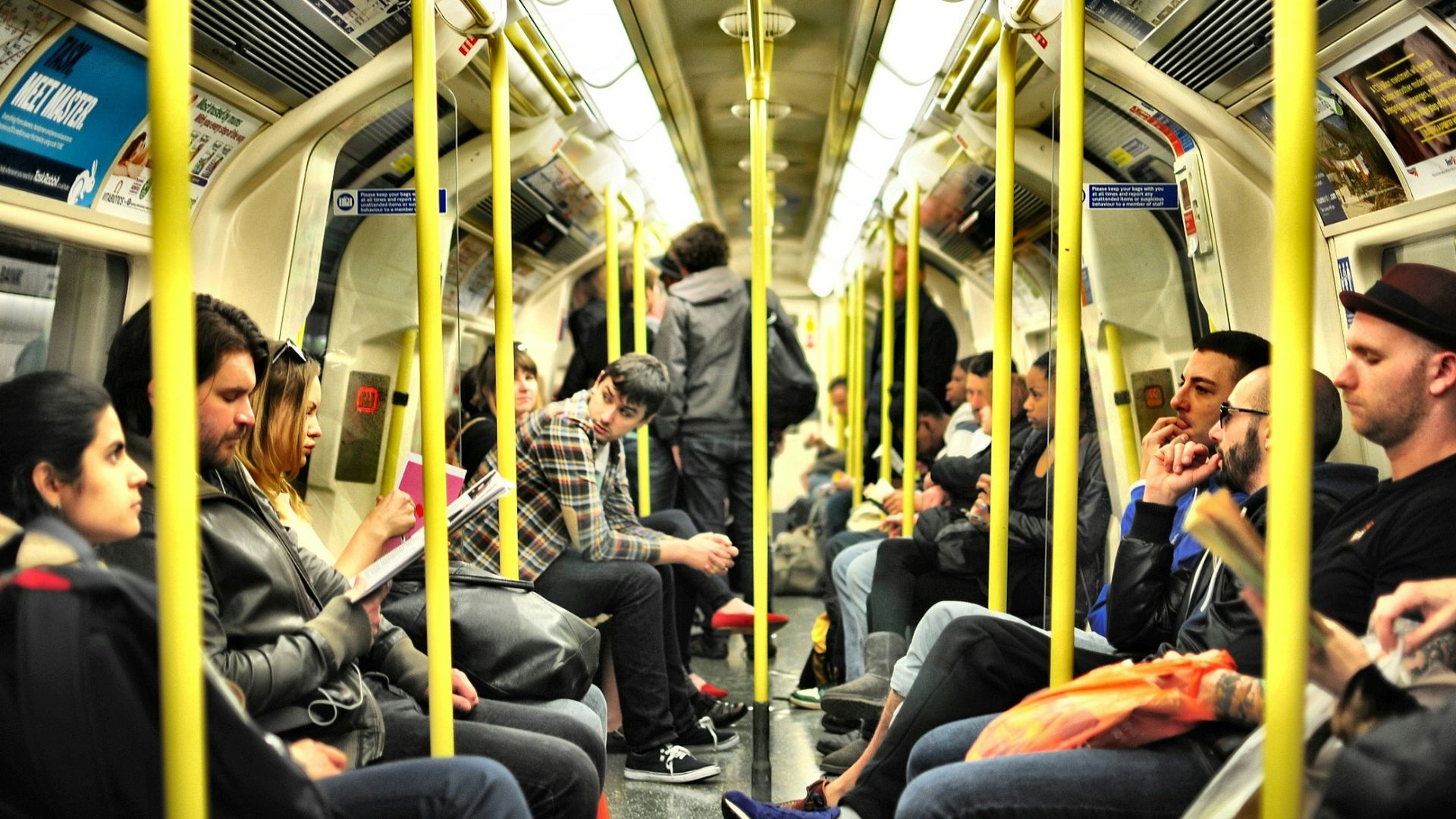 photo of group on people sitting inside train