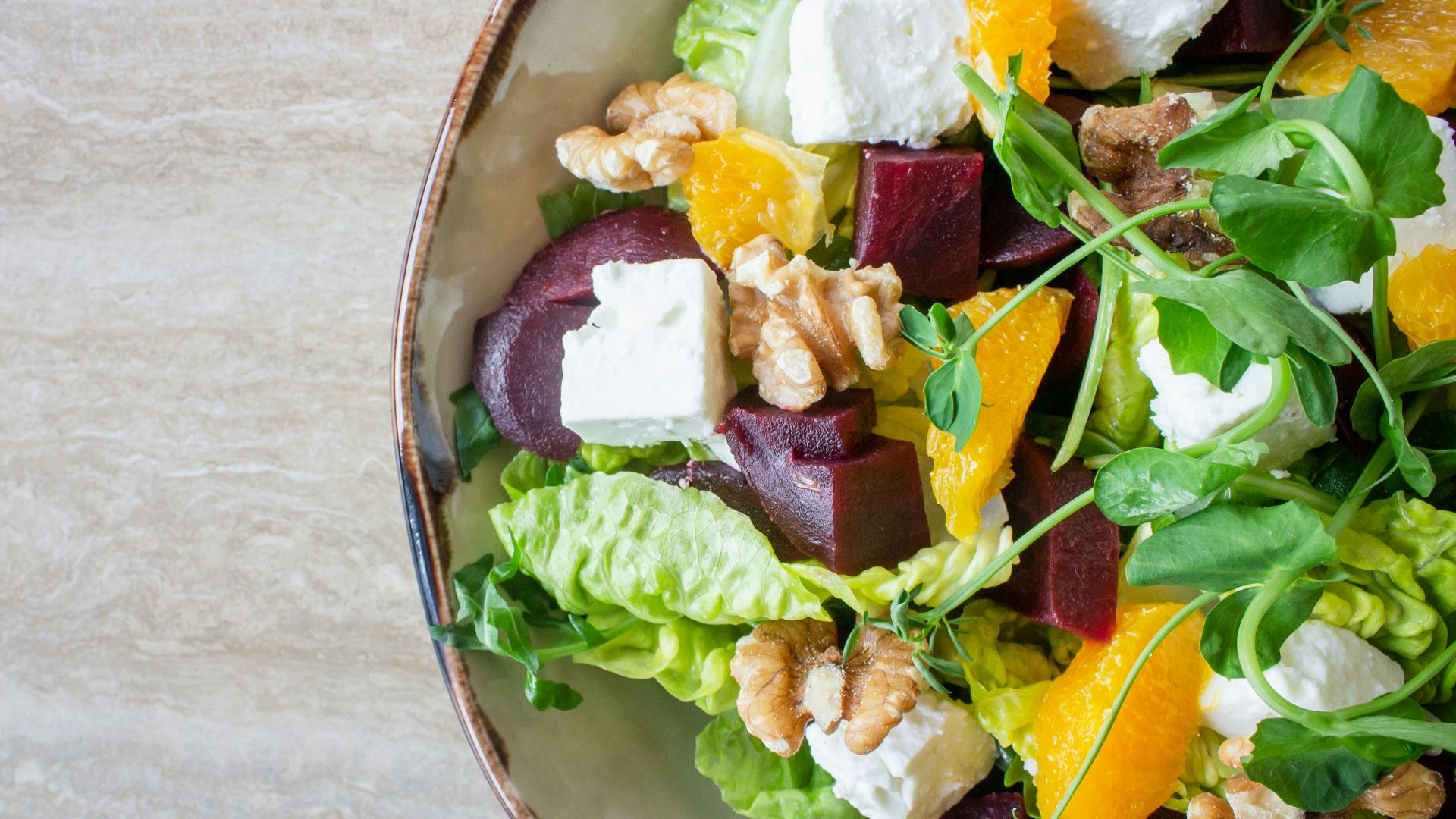 bowl of vegetable salad with walnuts