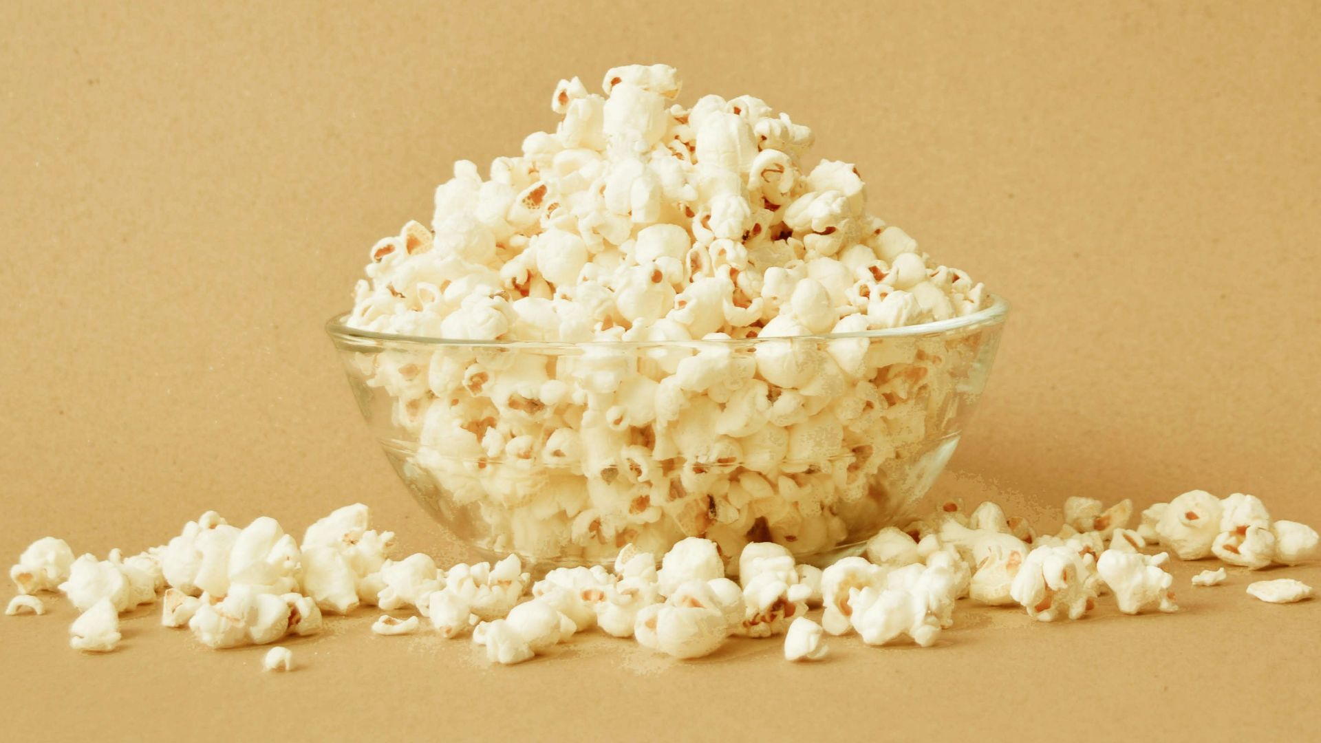 a bowl filled with popcorn sitting on top of a table