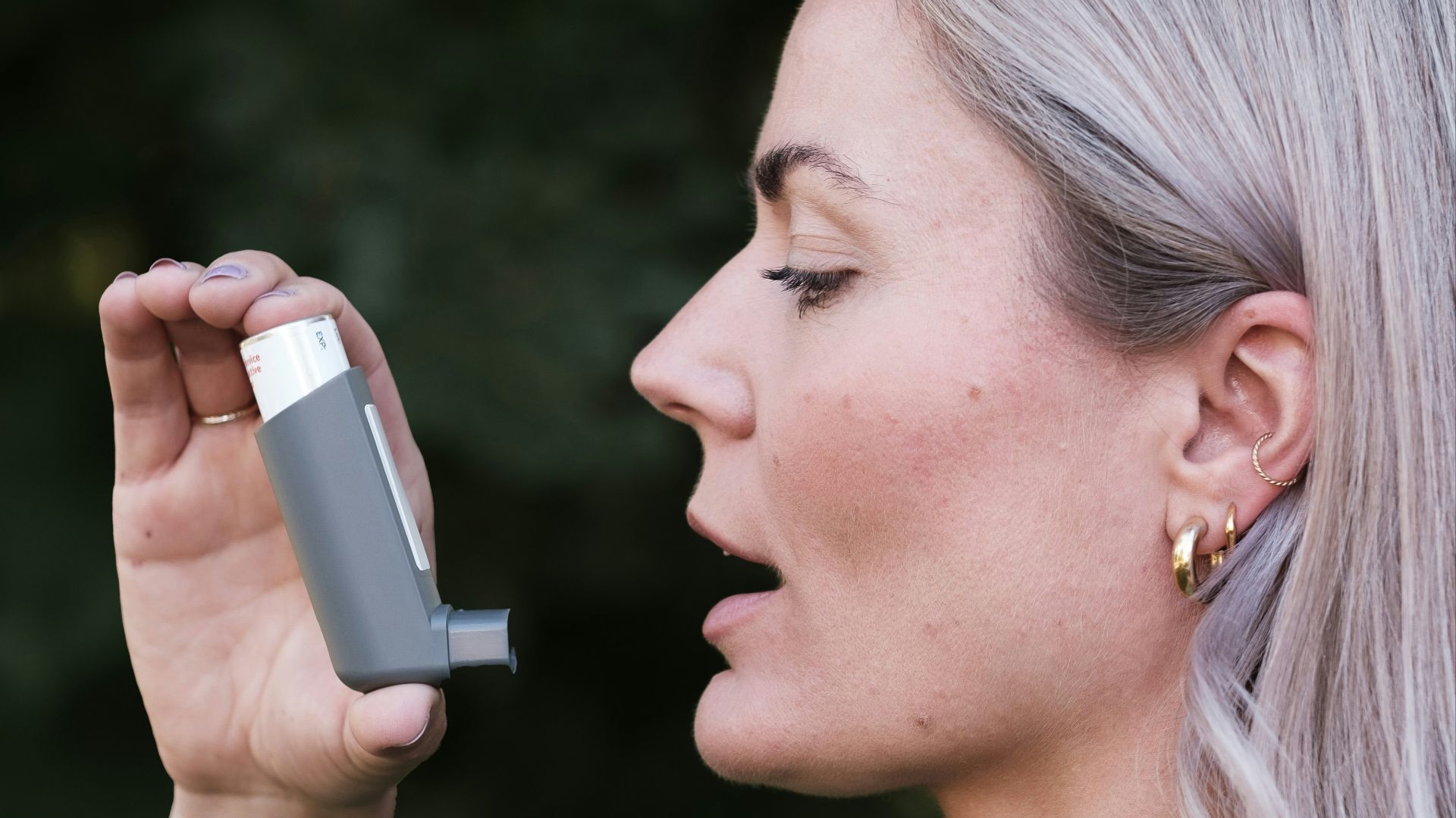A woman holding a cell phone up to her face