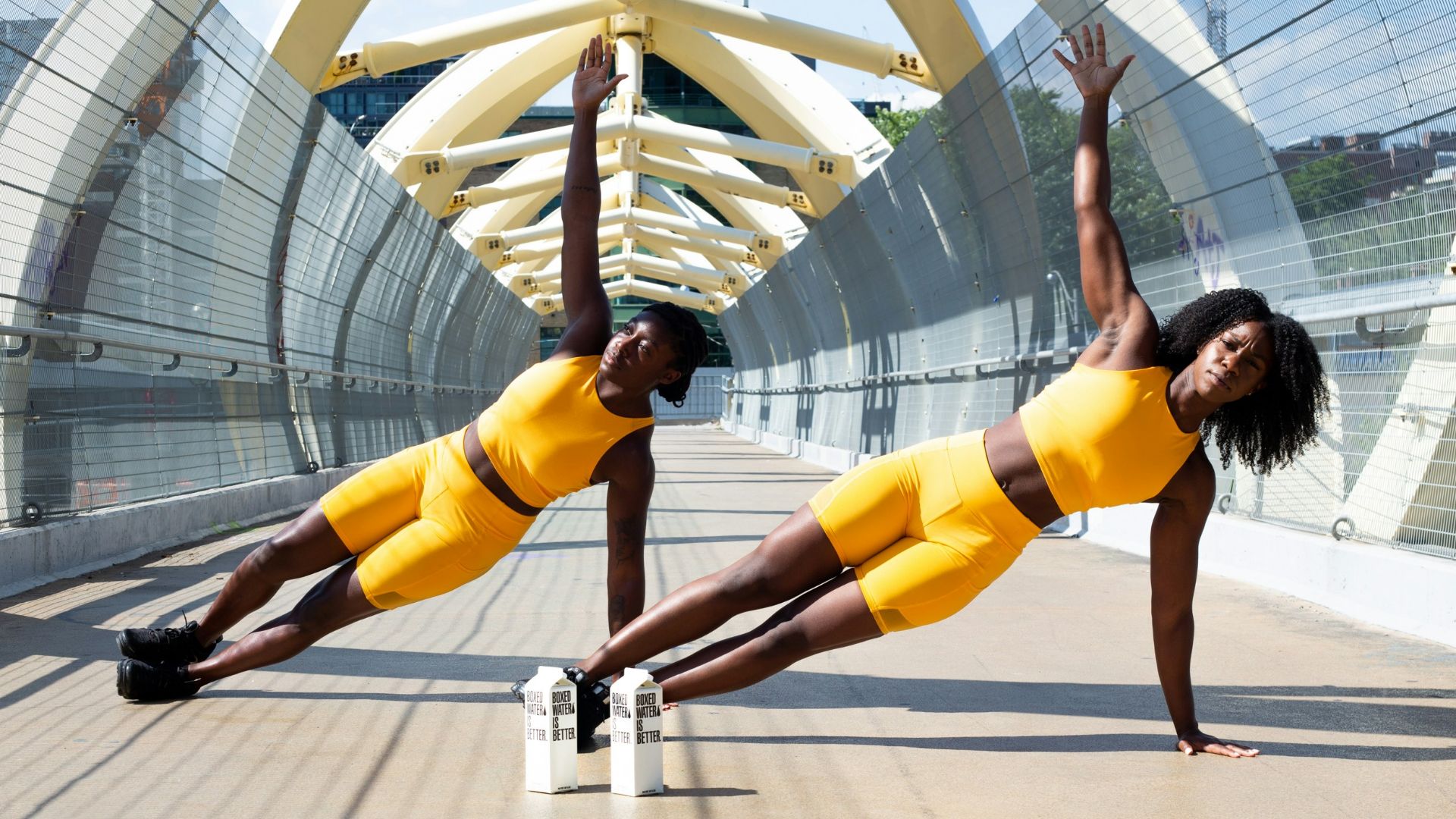 woman in yellow sports bra and yellow shorts jumping on white metal frame