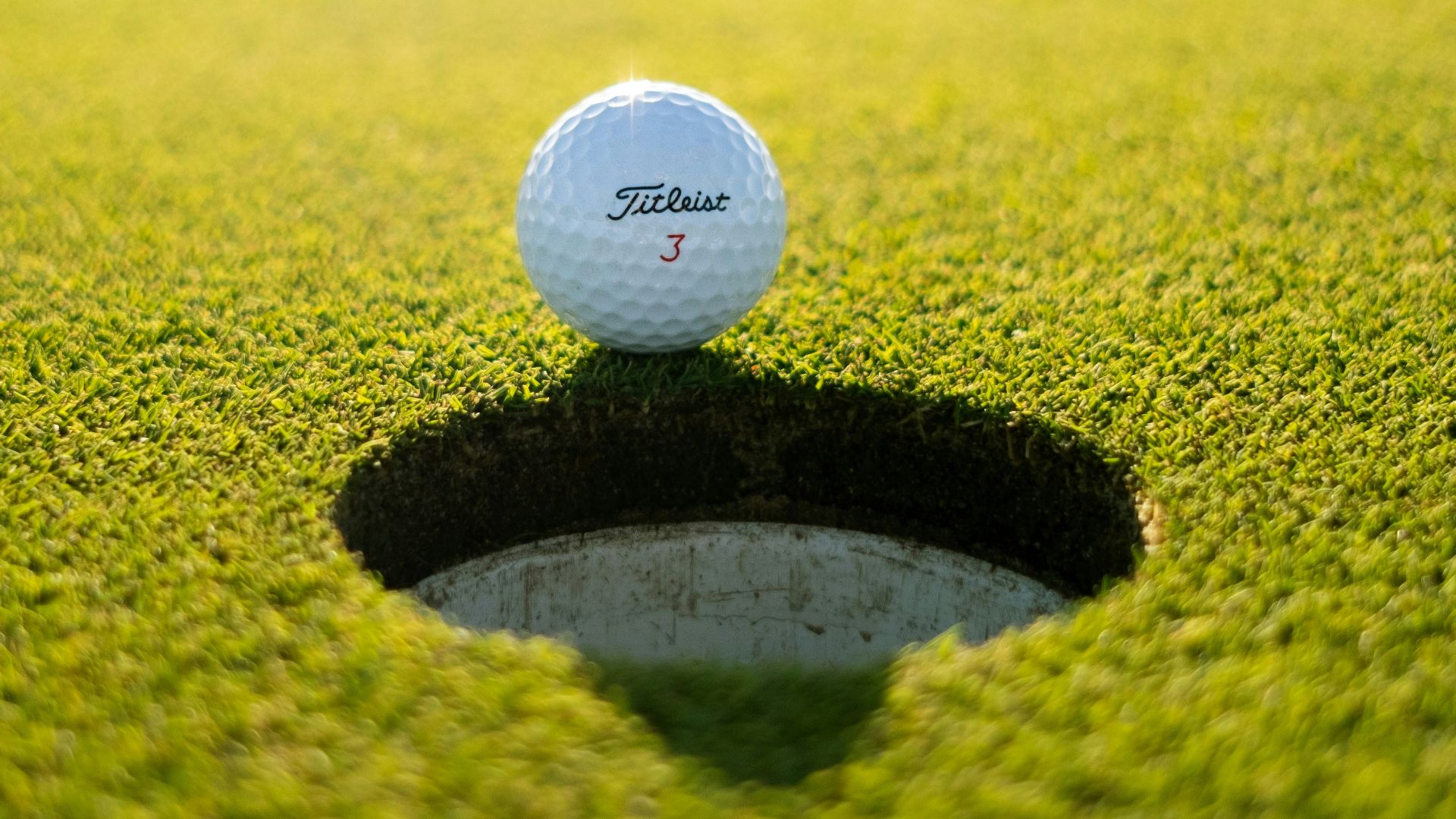 golf ball on green grass field during daytime