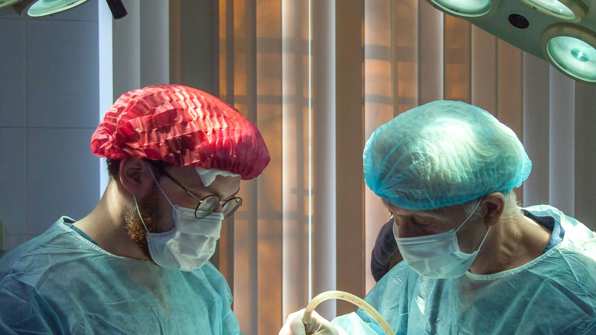 two men wearing blue lab coats