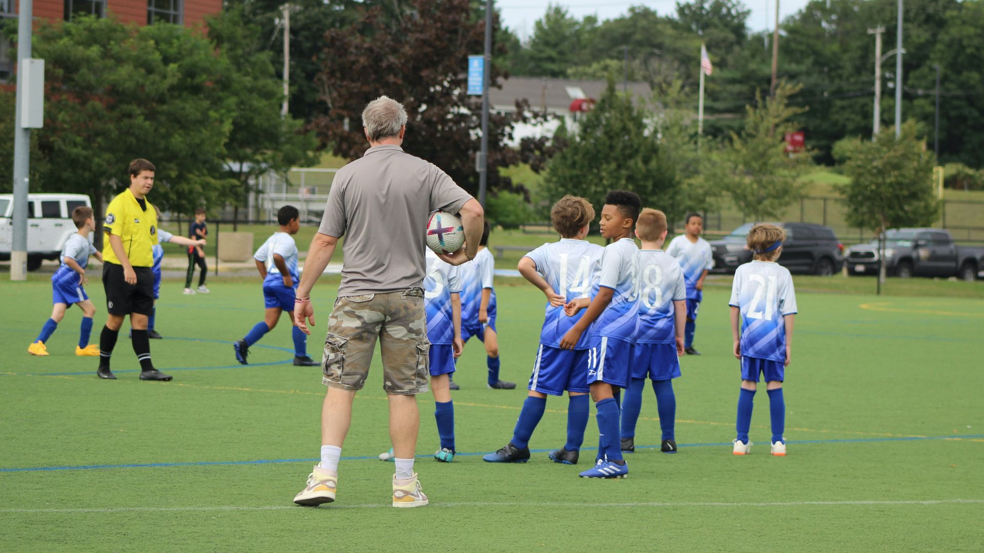 a group of young men standing on top of a soccer field