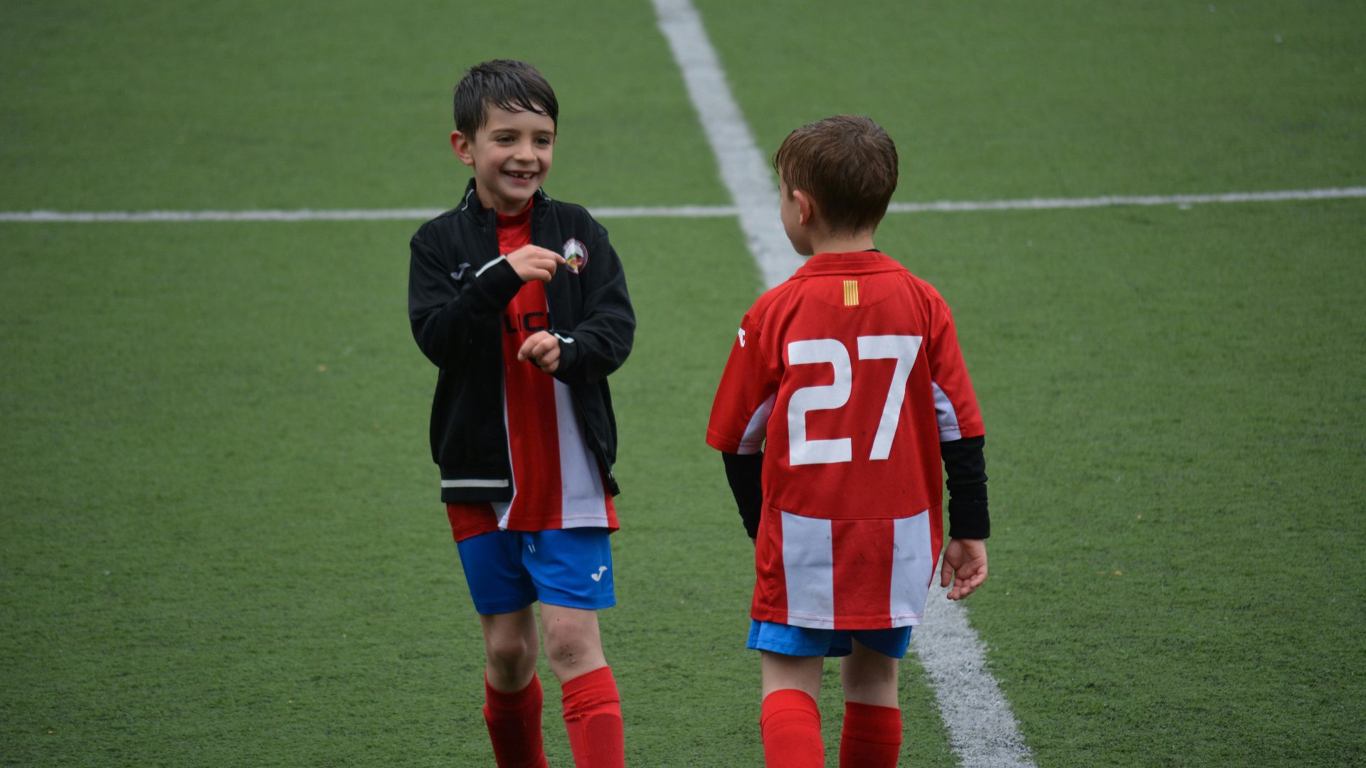 two boy standing on soccer field