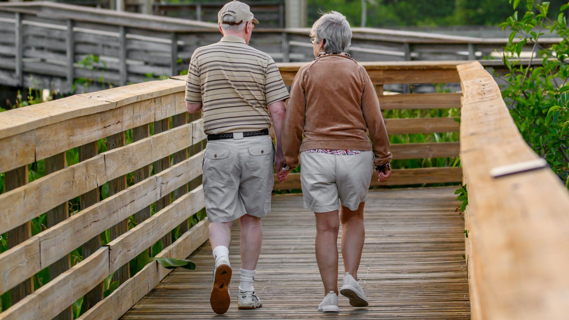 a couple of people that are walking on a bridge