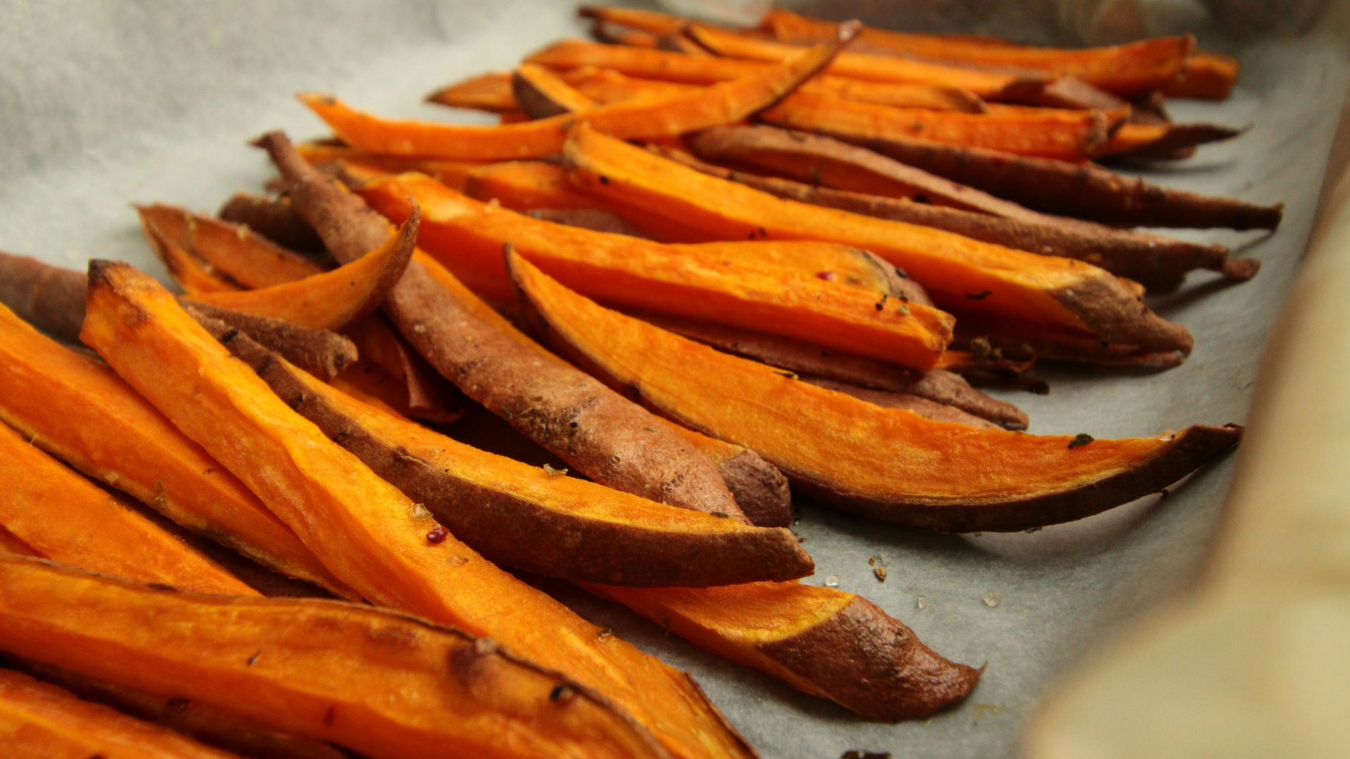 sliced orange fruit on white table