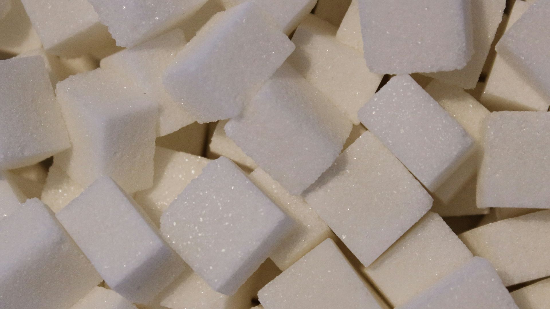 a pile of white sugar cubes sitting on top of a table