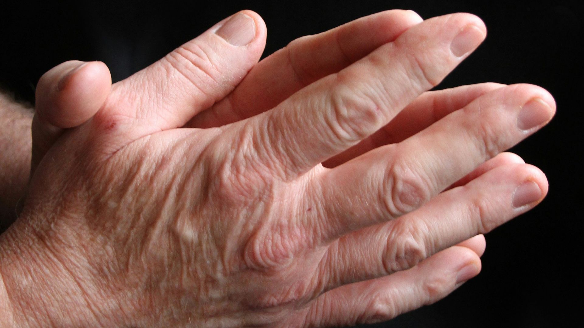 a close up of a person holding their hands together