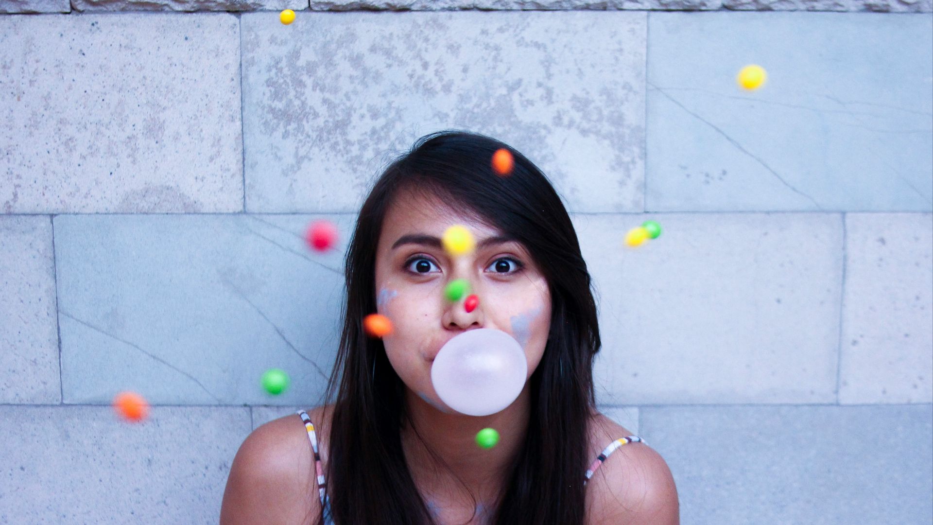 time lapse photo of woman making gum bubble
