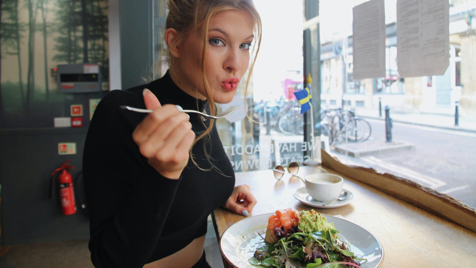 woman in black long sleeve shirt eating