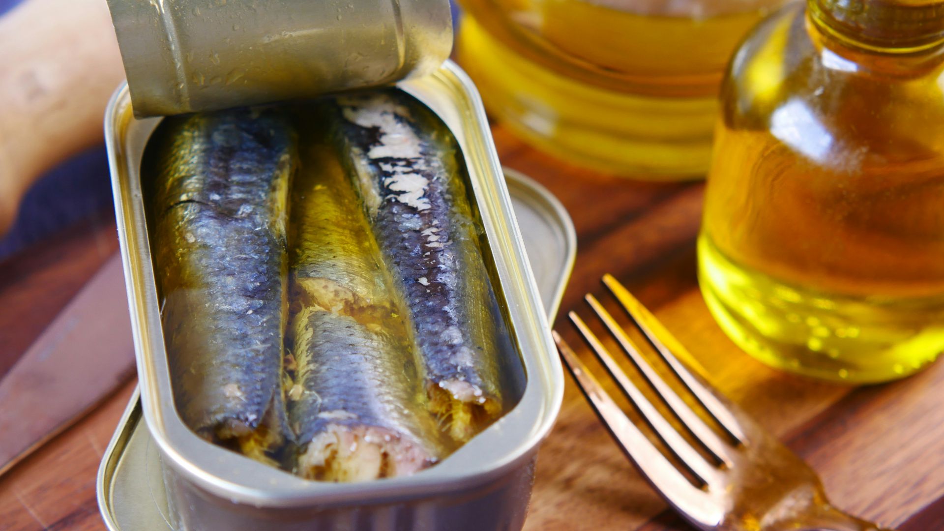 a tin of sardines sitting on top of a wooden table