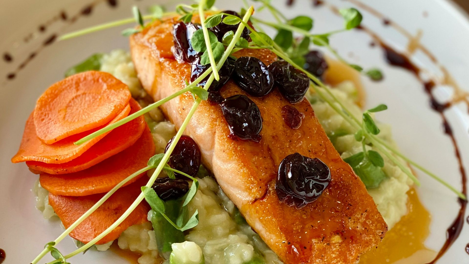 a white plate topped with fish and veggies