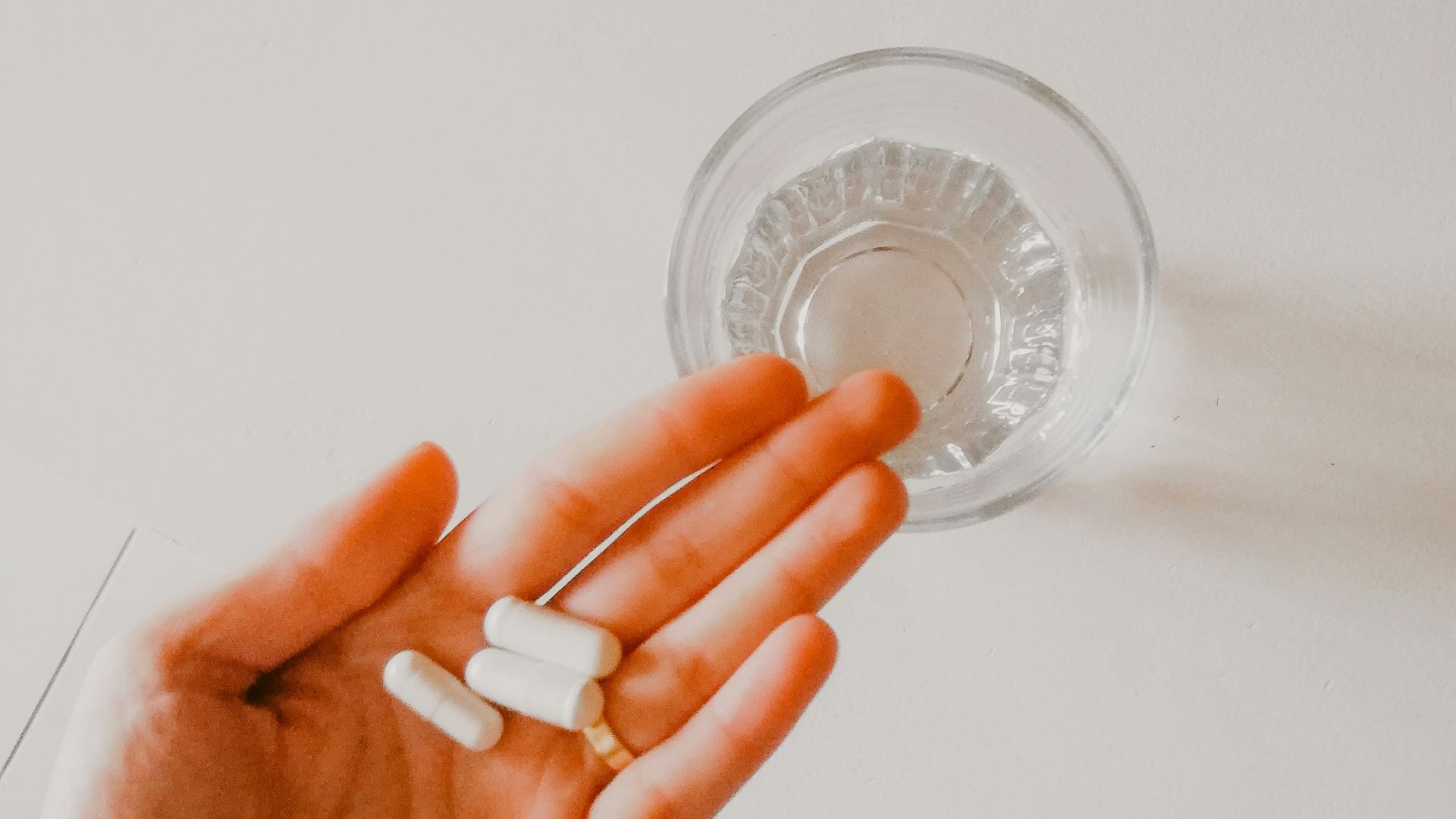 person holding white medication pill