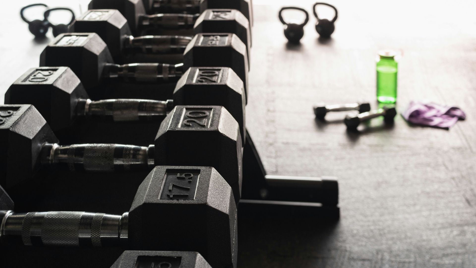 black and gray dumbbells on floor