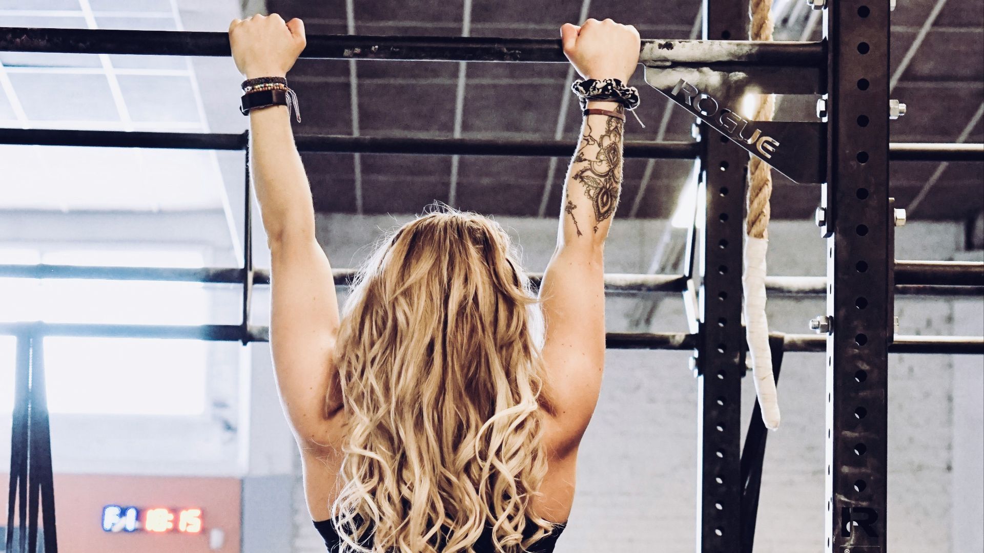 woman hanging on exercise equipment