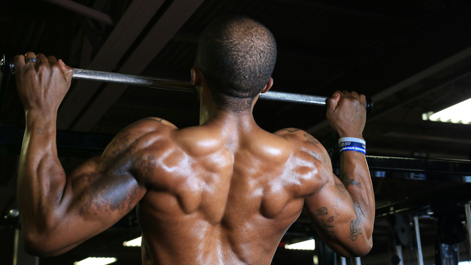 a man with a barbell in a gym