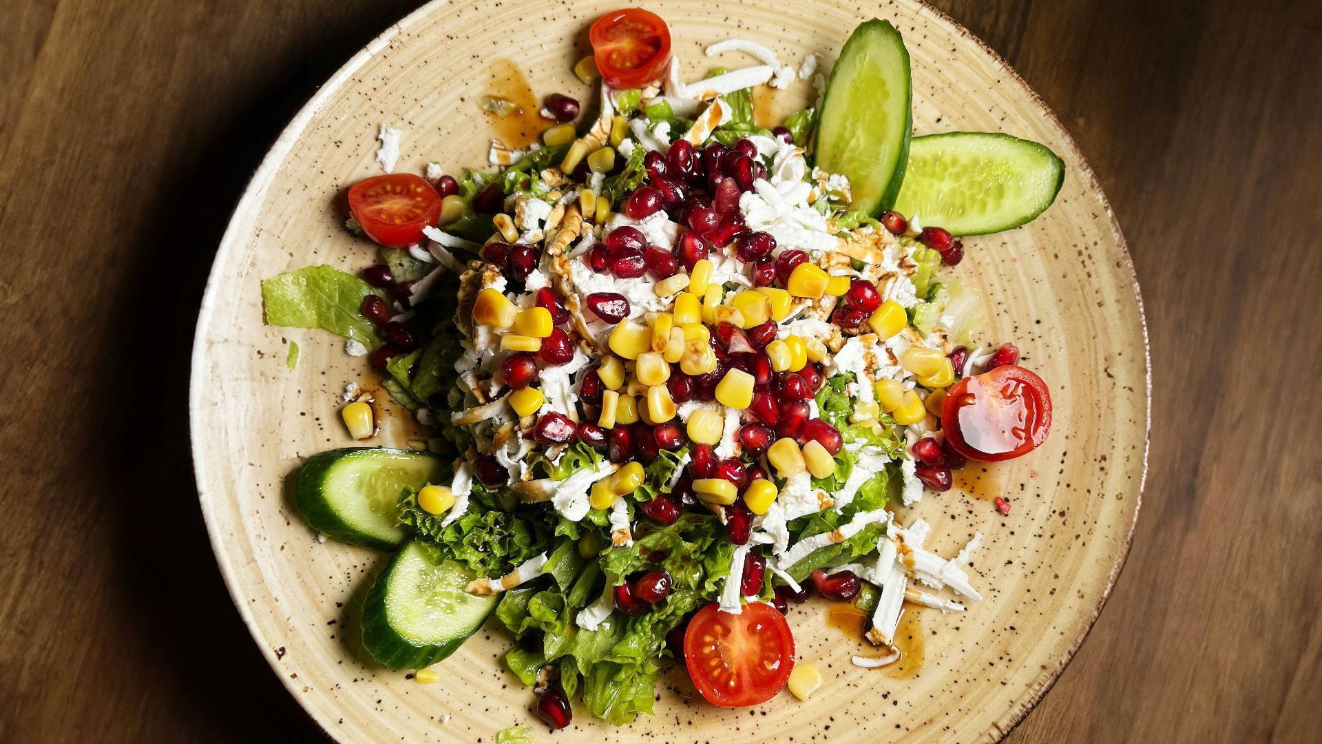 a plate of salad on a wooden table