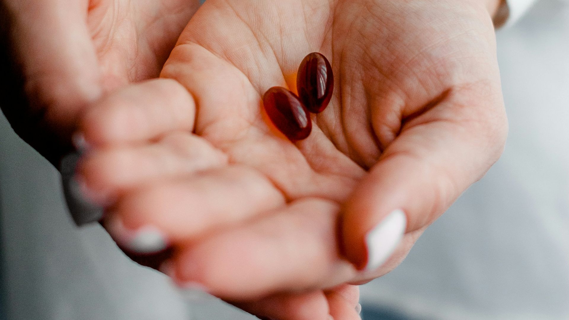 person holding brown and black round ornament