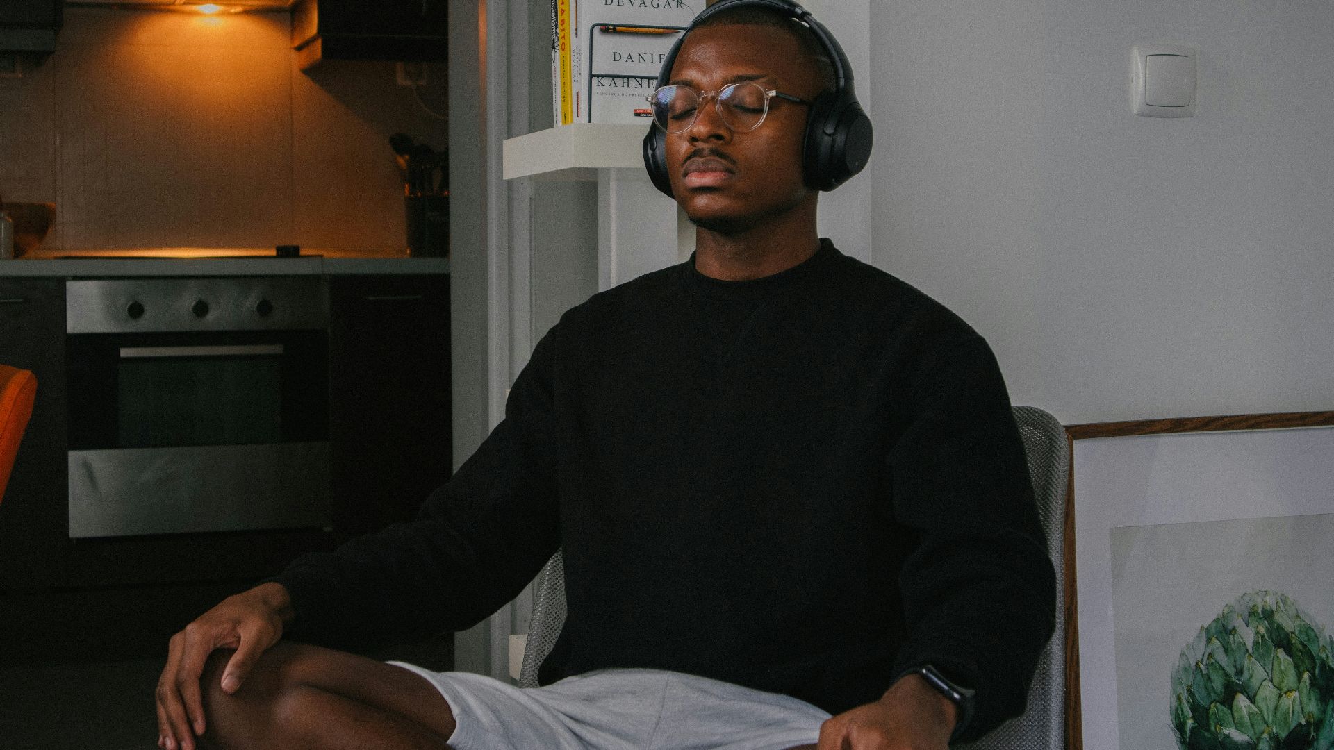 a man sitting in a chair wearing headphones