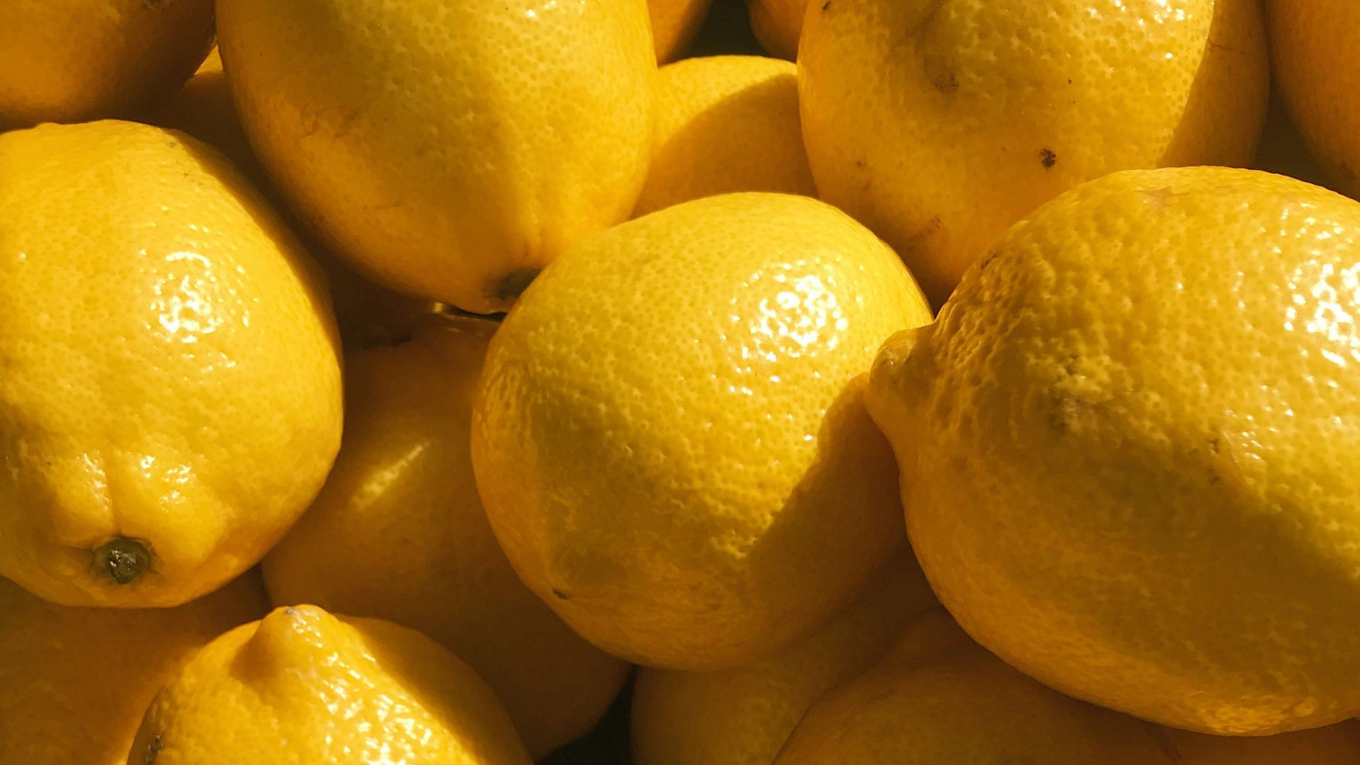 yellow lemon fruits on black surface
