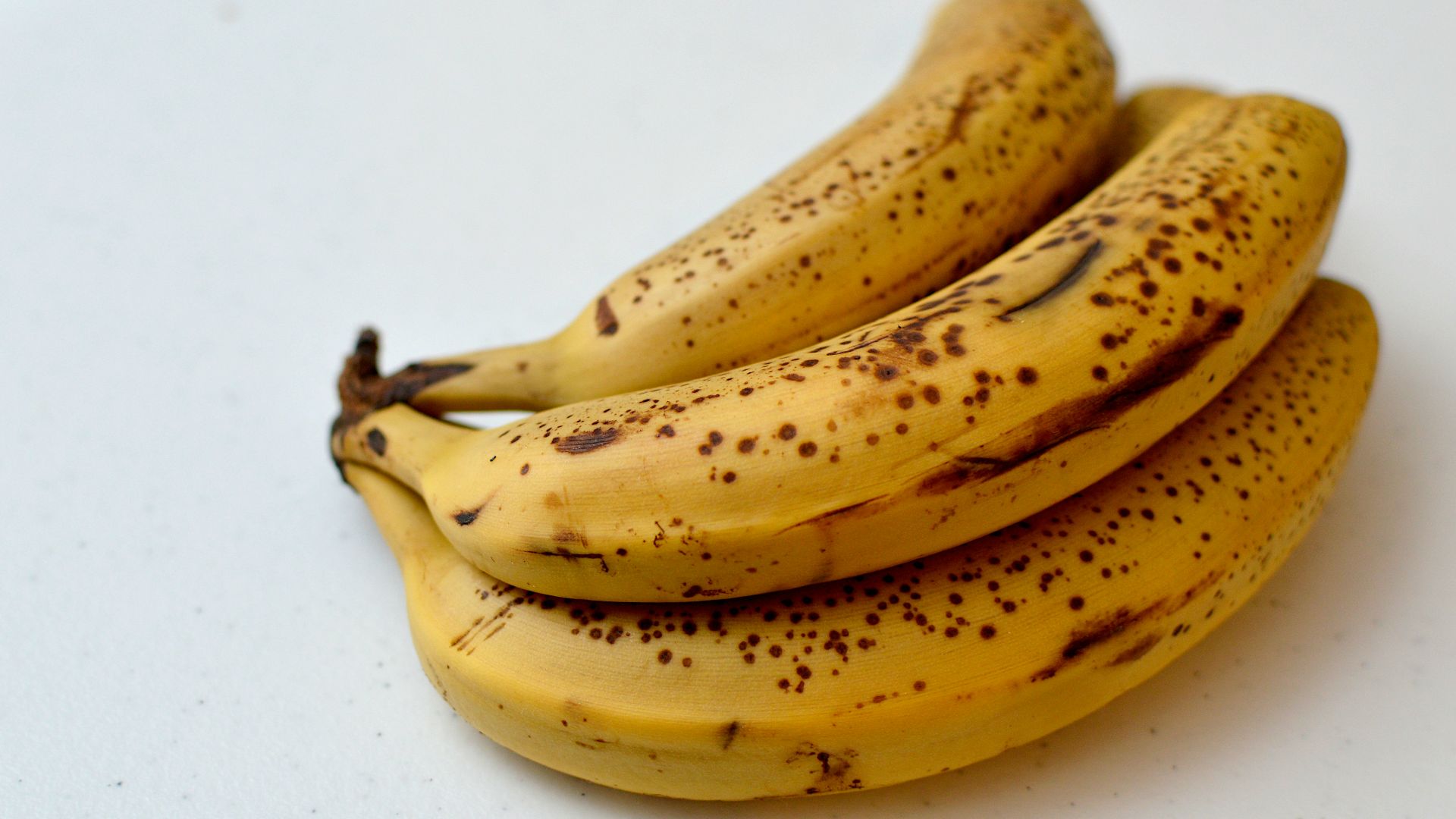 a bunch of ripe bananas sitting on top of a table