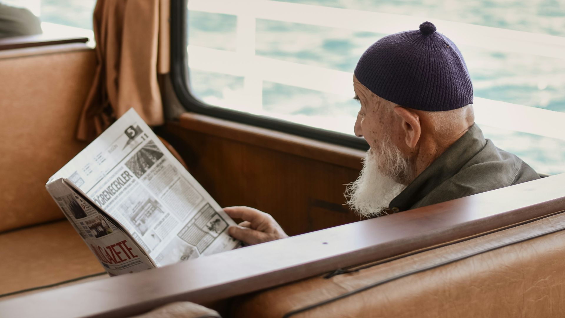 sitting man while reading newspaper