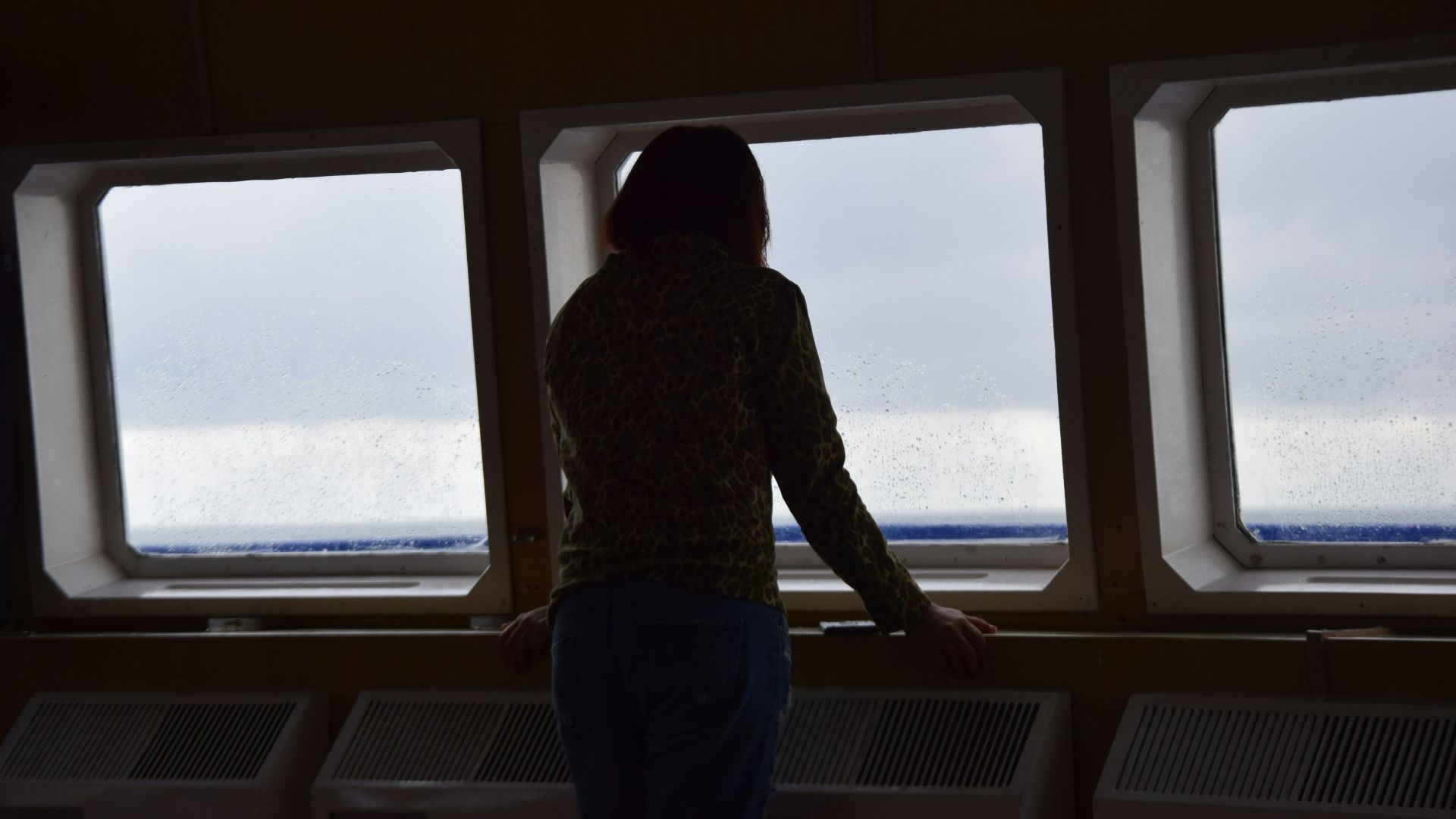 silhouette photo of woman leaning forward