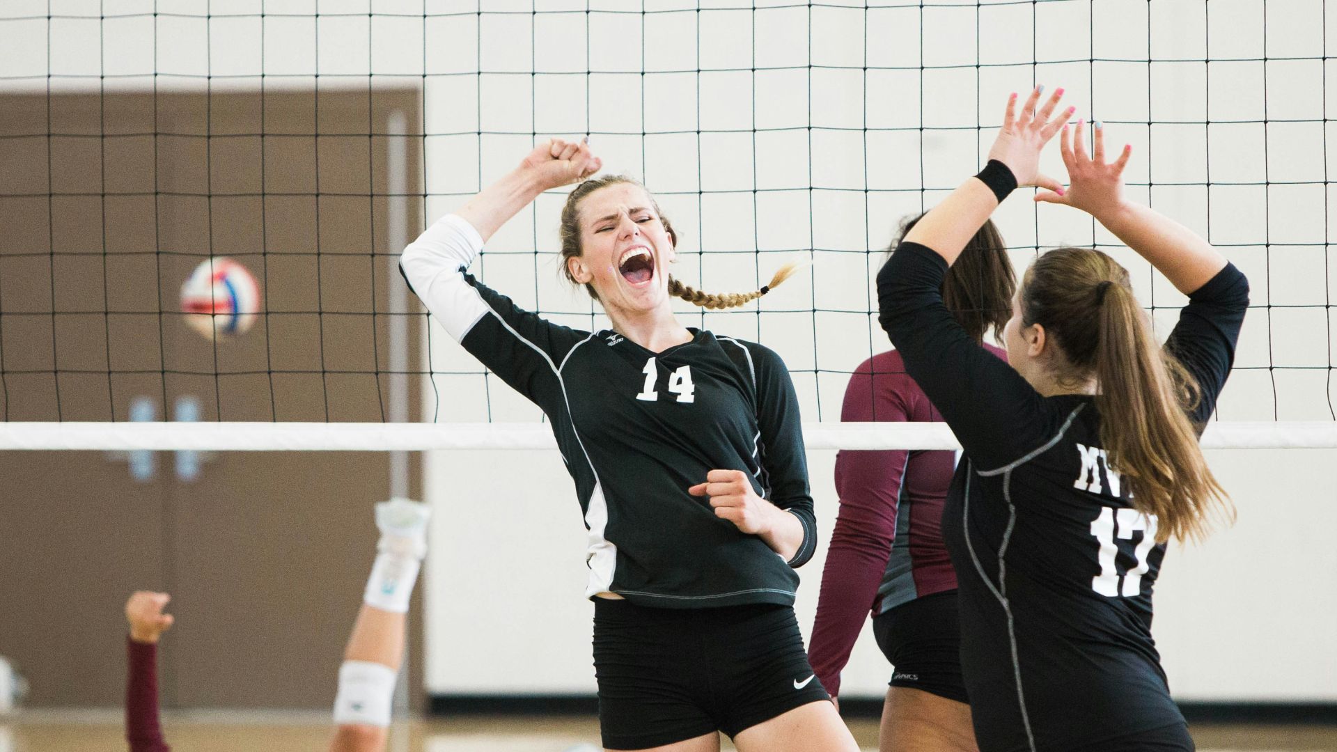 women playing volleyball inside court