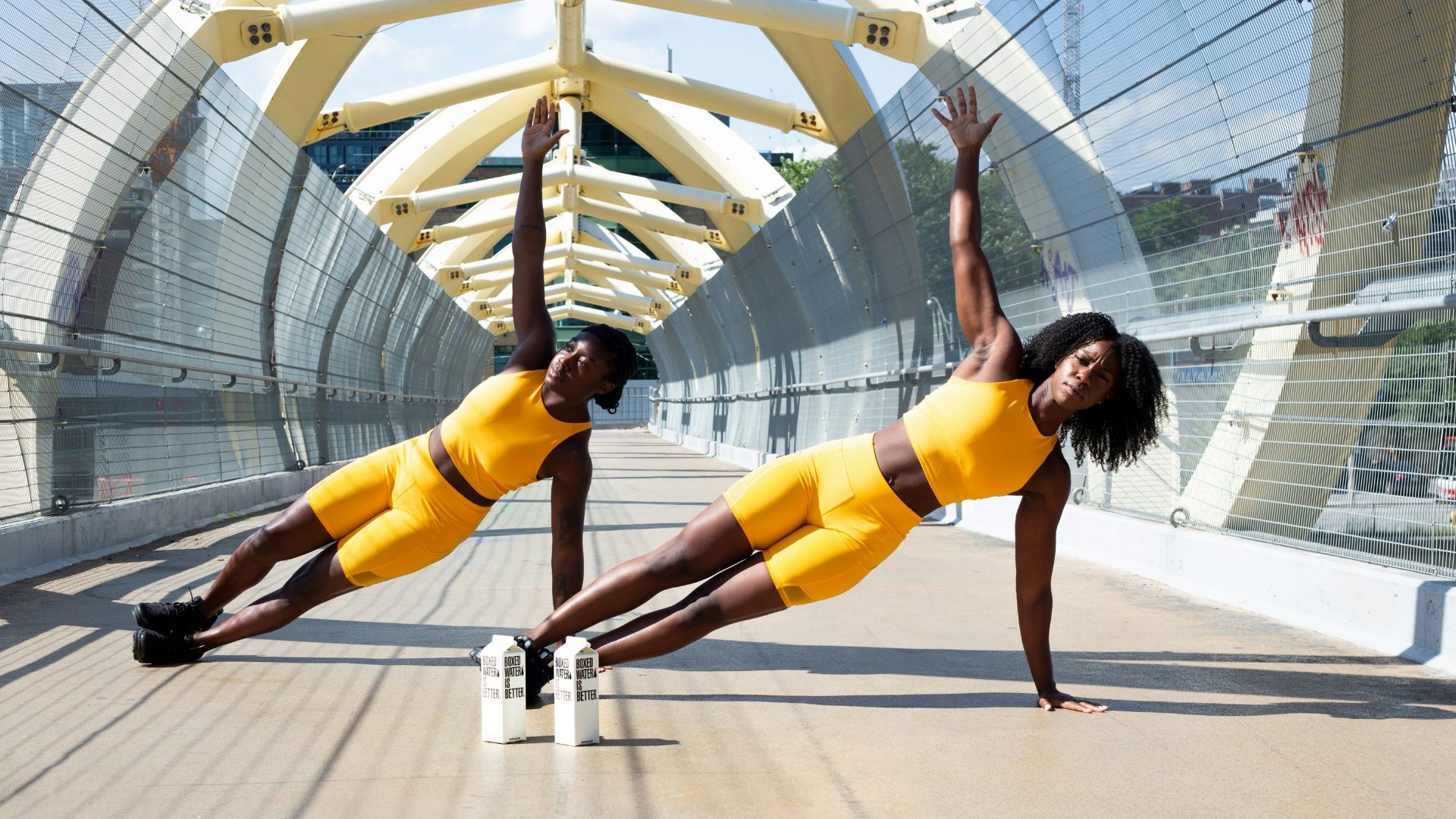 woman in yellow sports bra and yellow shorts jumping on white metal frame