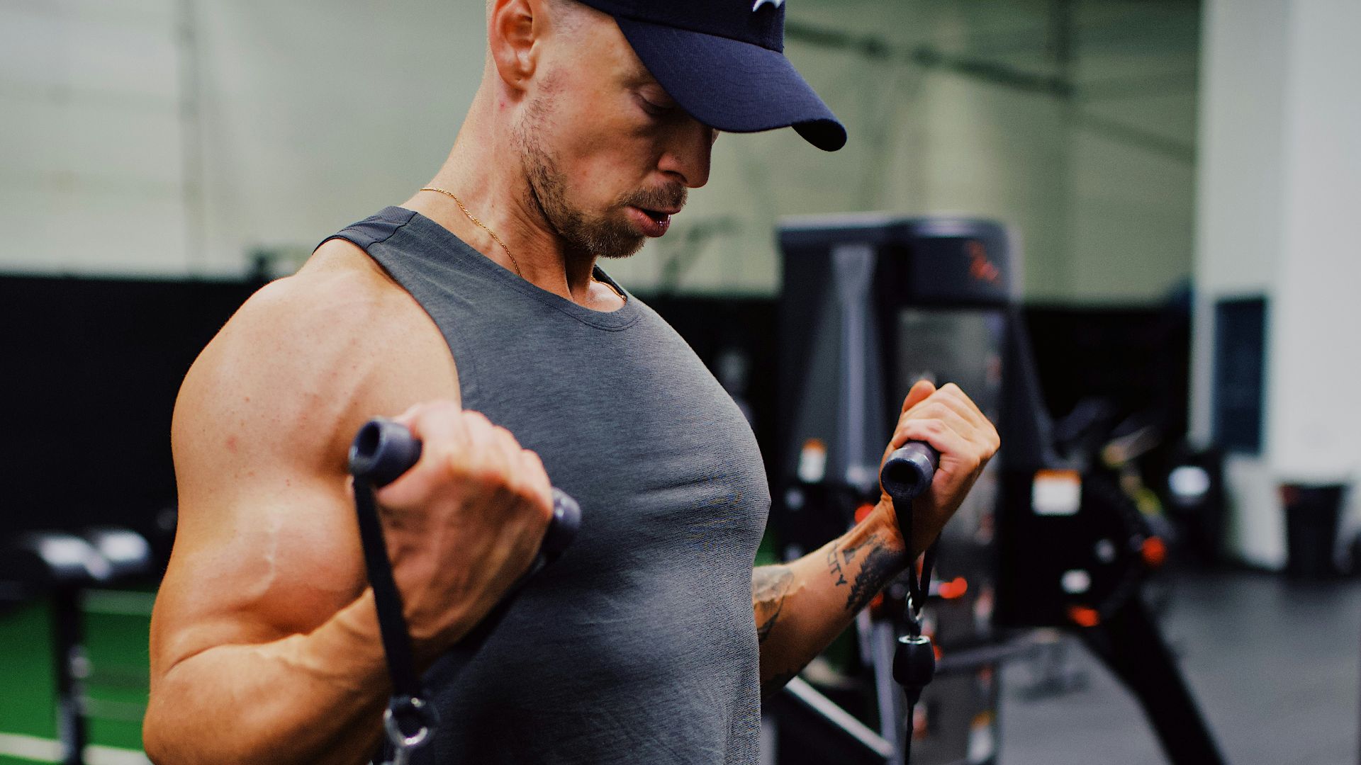 man in gray crew neck t-shirt and black pants holding black smartphone