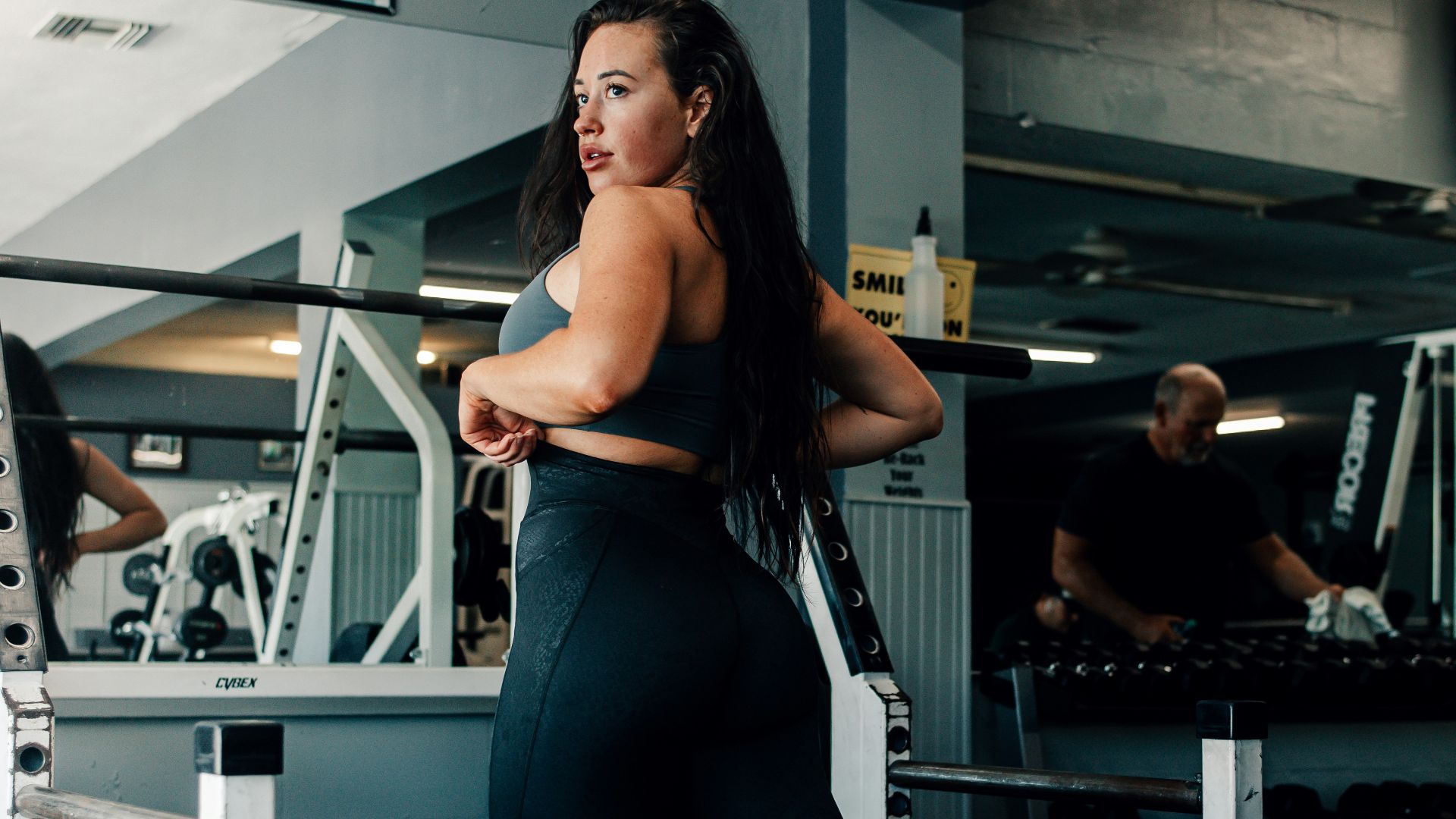 a woman standing on a machine in a gym