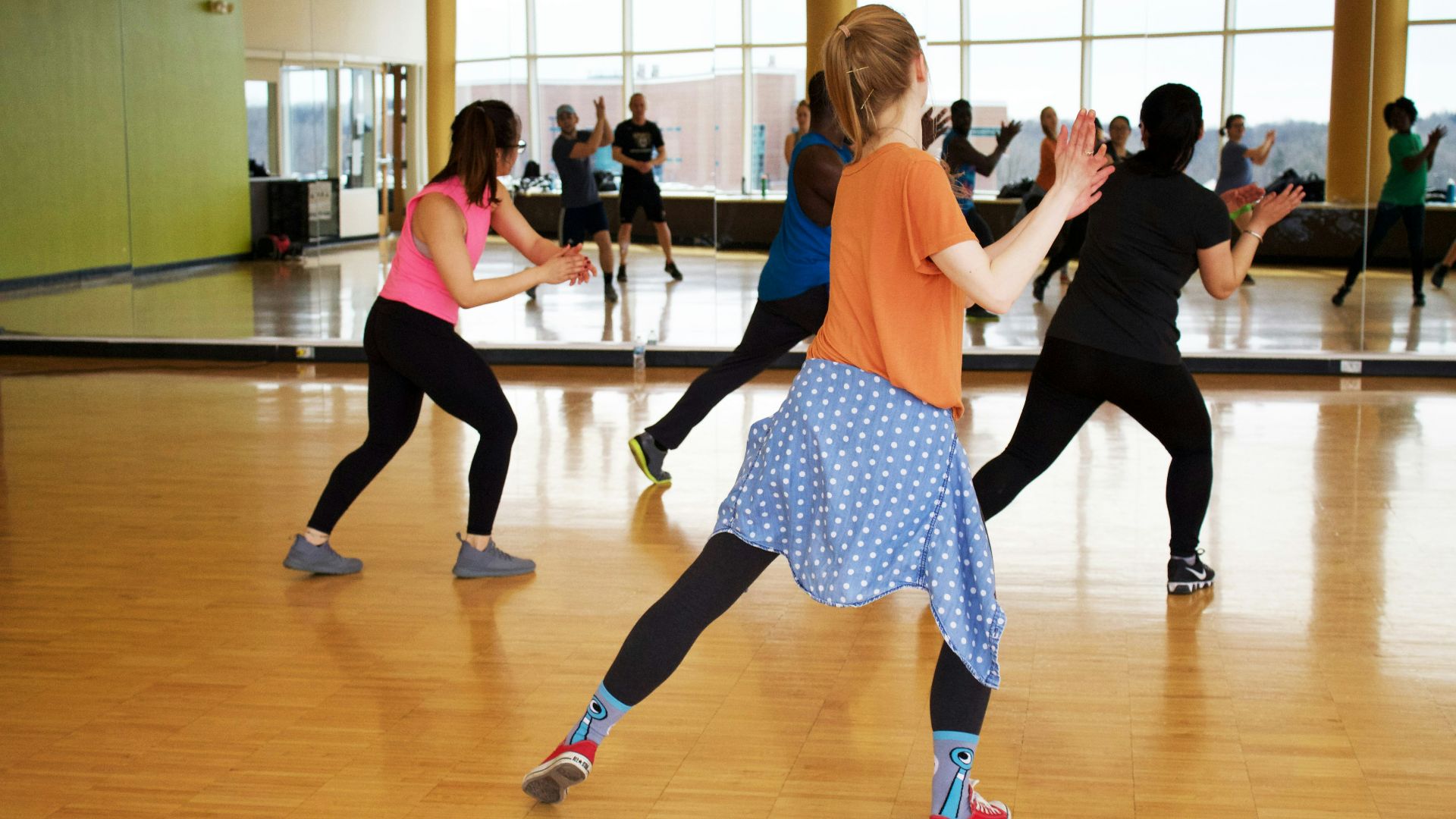 women dancing near mirror