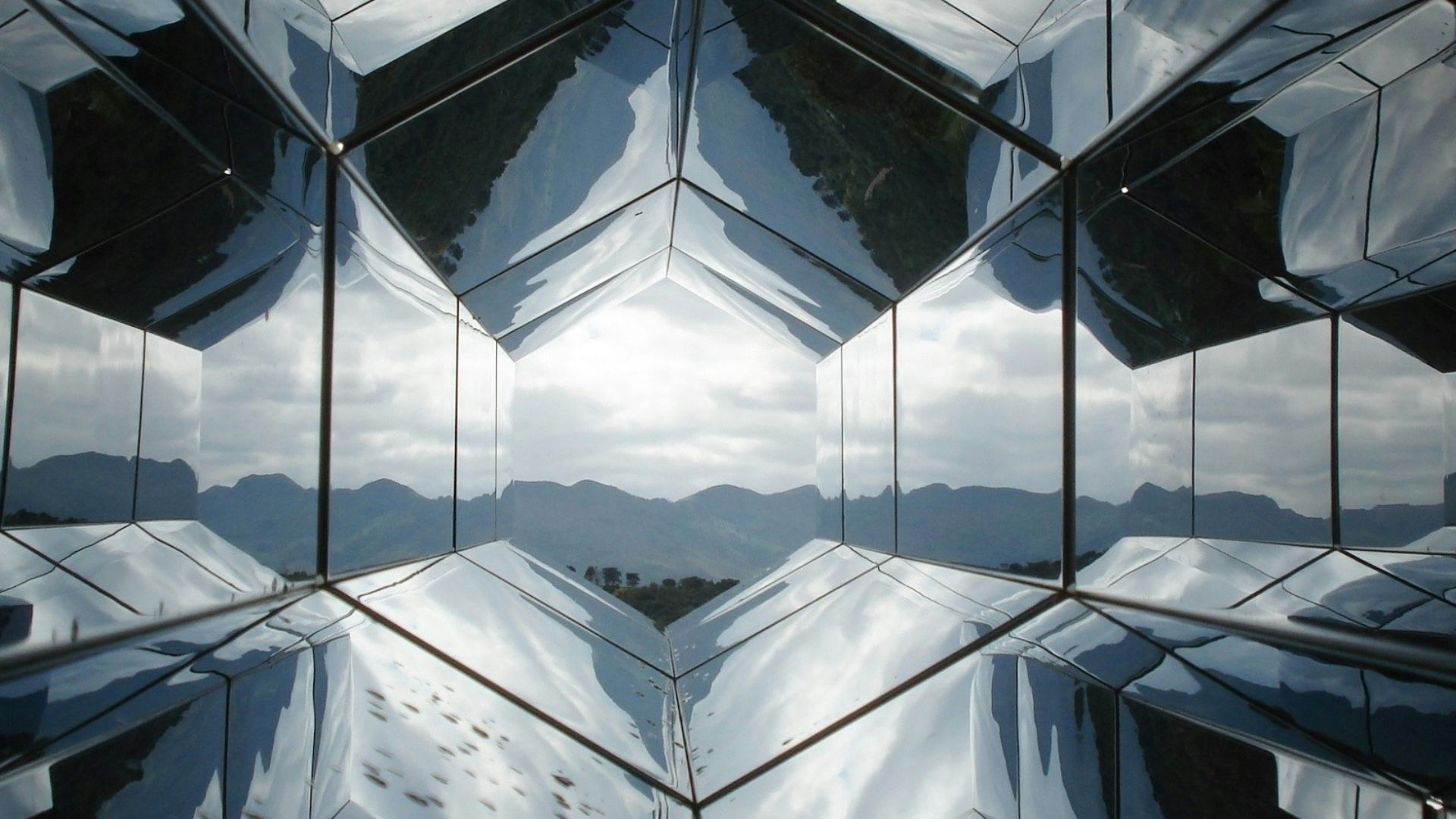 the reflection of the sky in the glass of a building