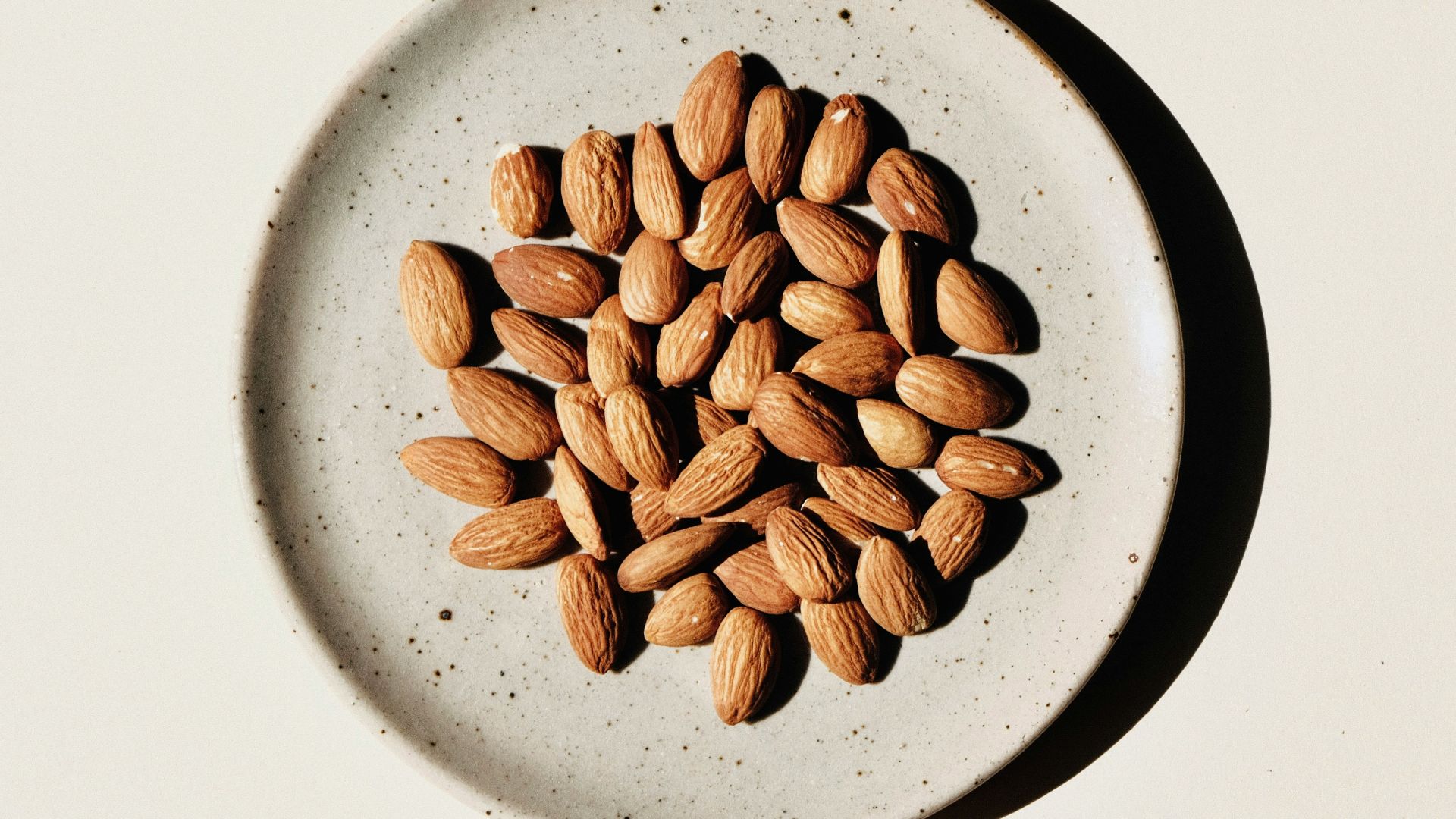 brown coffee beans on white ceramic bowl